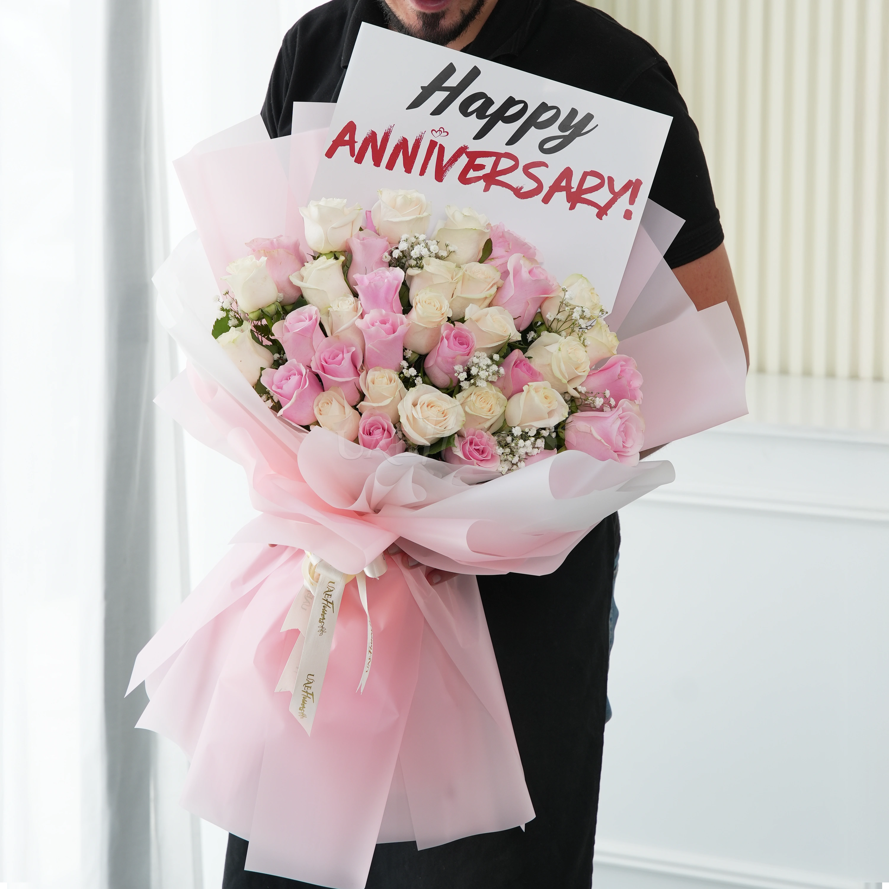 Bouquet of 15 pink roses and 20 white roses with green fillers in nice wrapping.