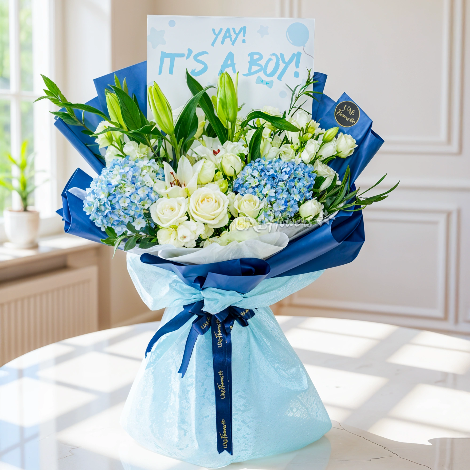 Bouquet of 2 blue hydrangeas, 2 white lilies, 5 white roses and 3 white spray roses with green fillers