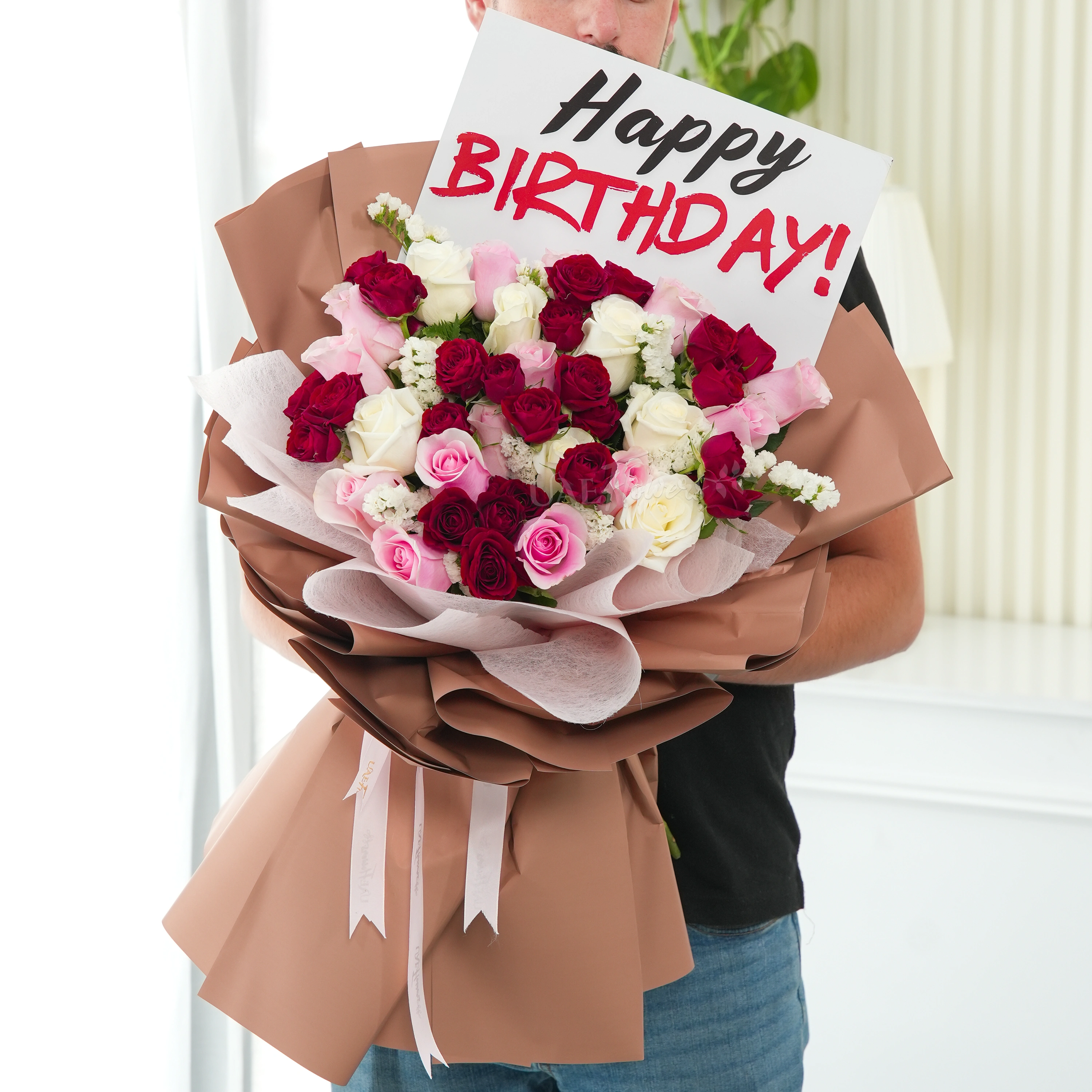 Bouquet of 20 pink and white roses, 5 red spray roses and white statis with green fillers in nice wrapping.