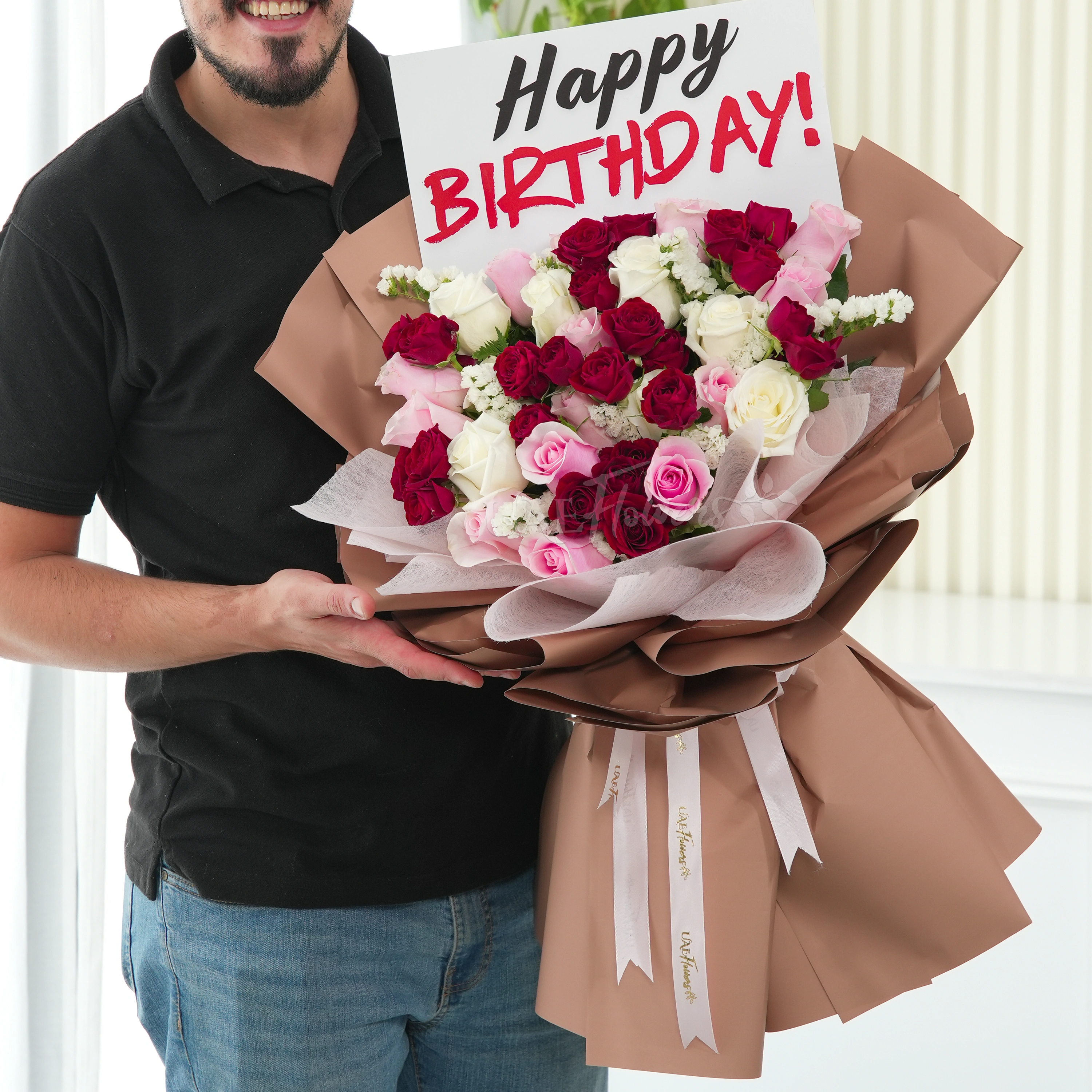 Bouquet of 20 pink and white roses, 5 red spray roses and white statis with green fillers in nice wrapping.
