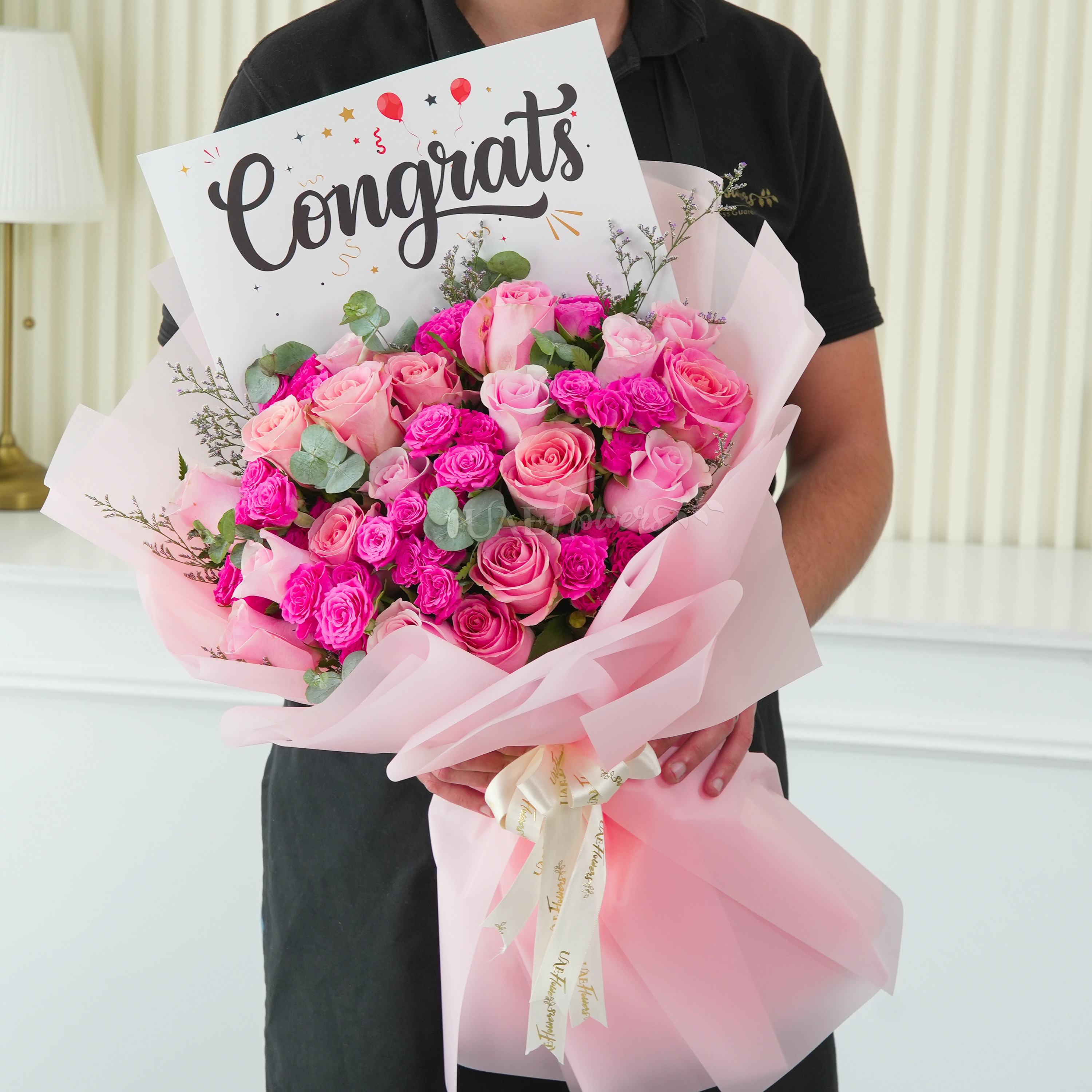 Bouquet of 15 pink roses and 5 pink spray roses with greens in nice wrapping.