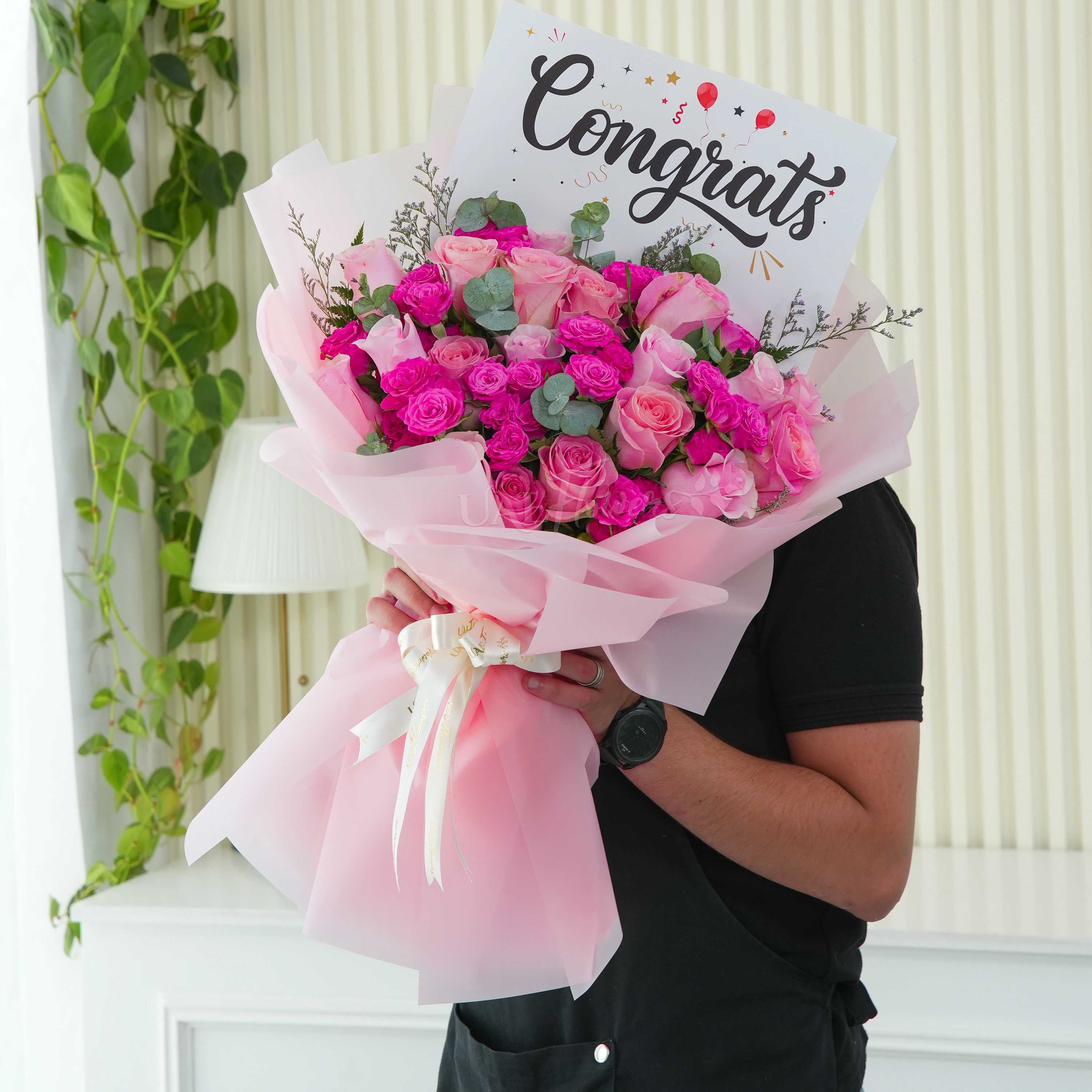 Bouquet of 15 pink roses and 5 pink spray roses with greens in nice wrapping.