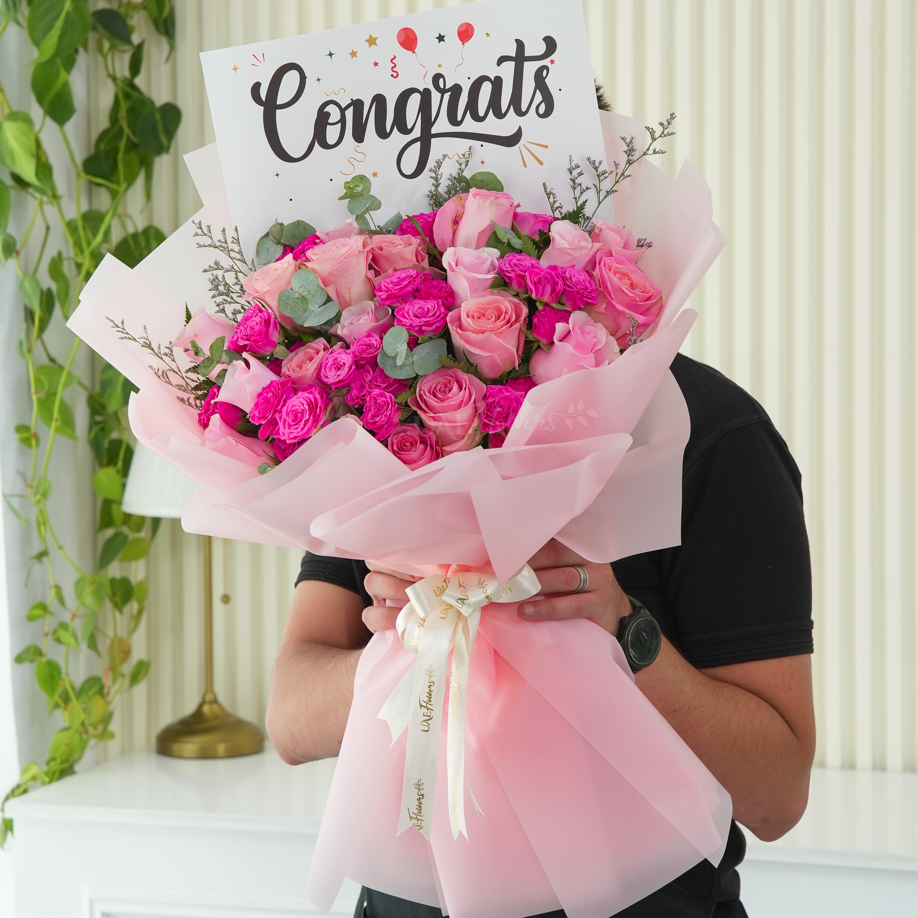 Bouquet of 15 pink roses and 5 pink spray roses with greens in nice wrapping.