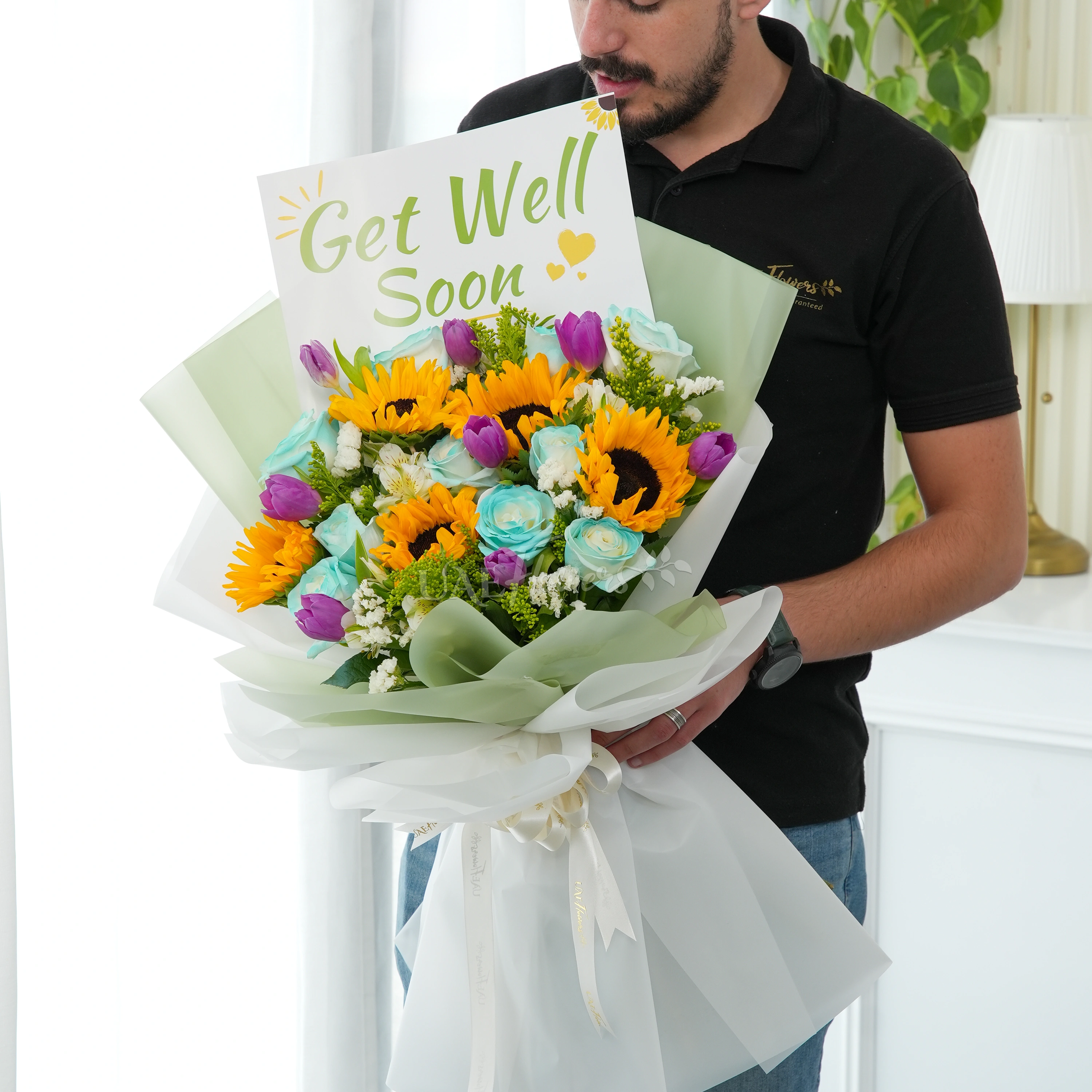 Bouquet of 5 sunflowers, 10 blue roses, 8 purple tulips, 3 white alstromeria and white statis with green fillers in nice wrapping.