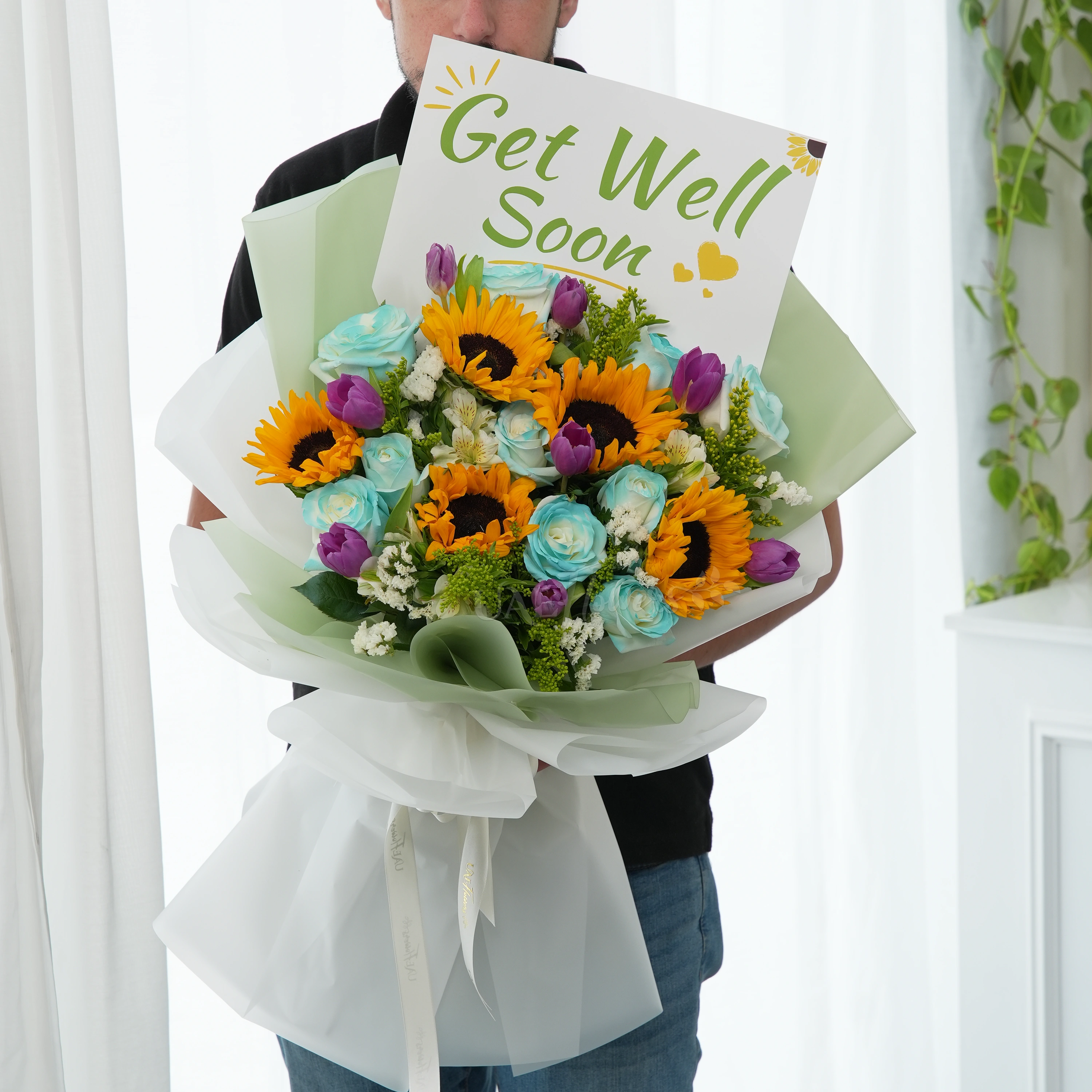 Bouquet of 5 sunflowers, 10 blue roses, 8 purple tulips, 3 white alstromeria and white statis with green fillers in nice wrapping.