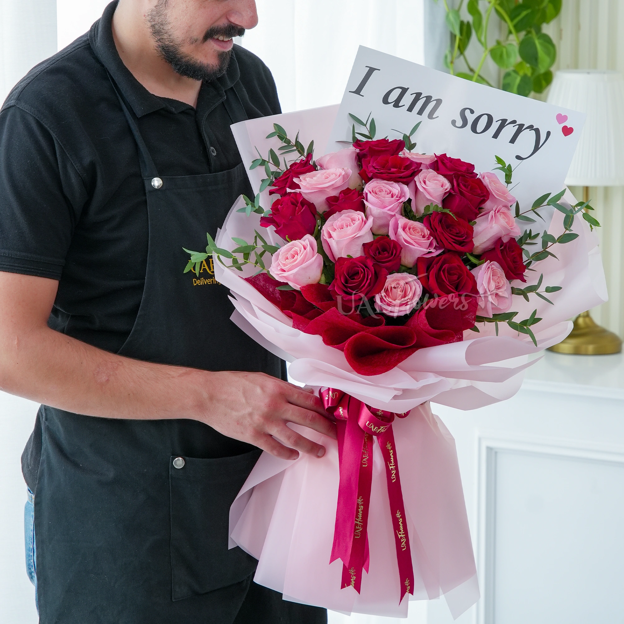 Bouquet of 24 red and pink roses with green fillers in nice wrapping.