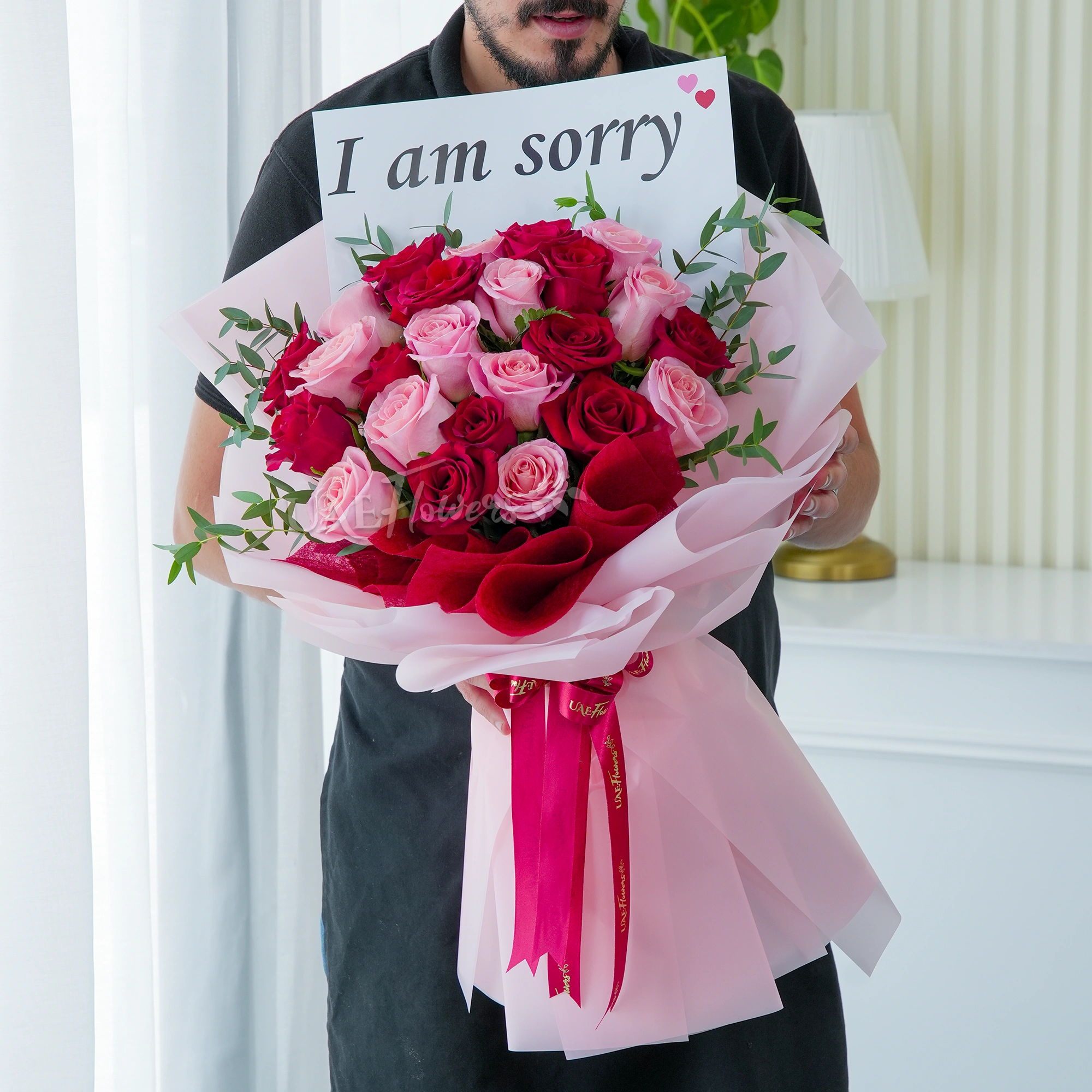 Bouquet of 24 red and pink roses with green fillers in nice wrapping.