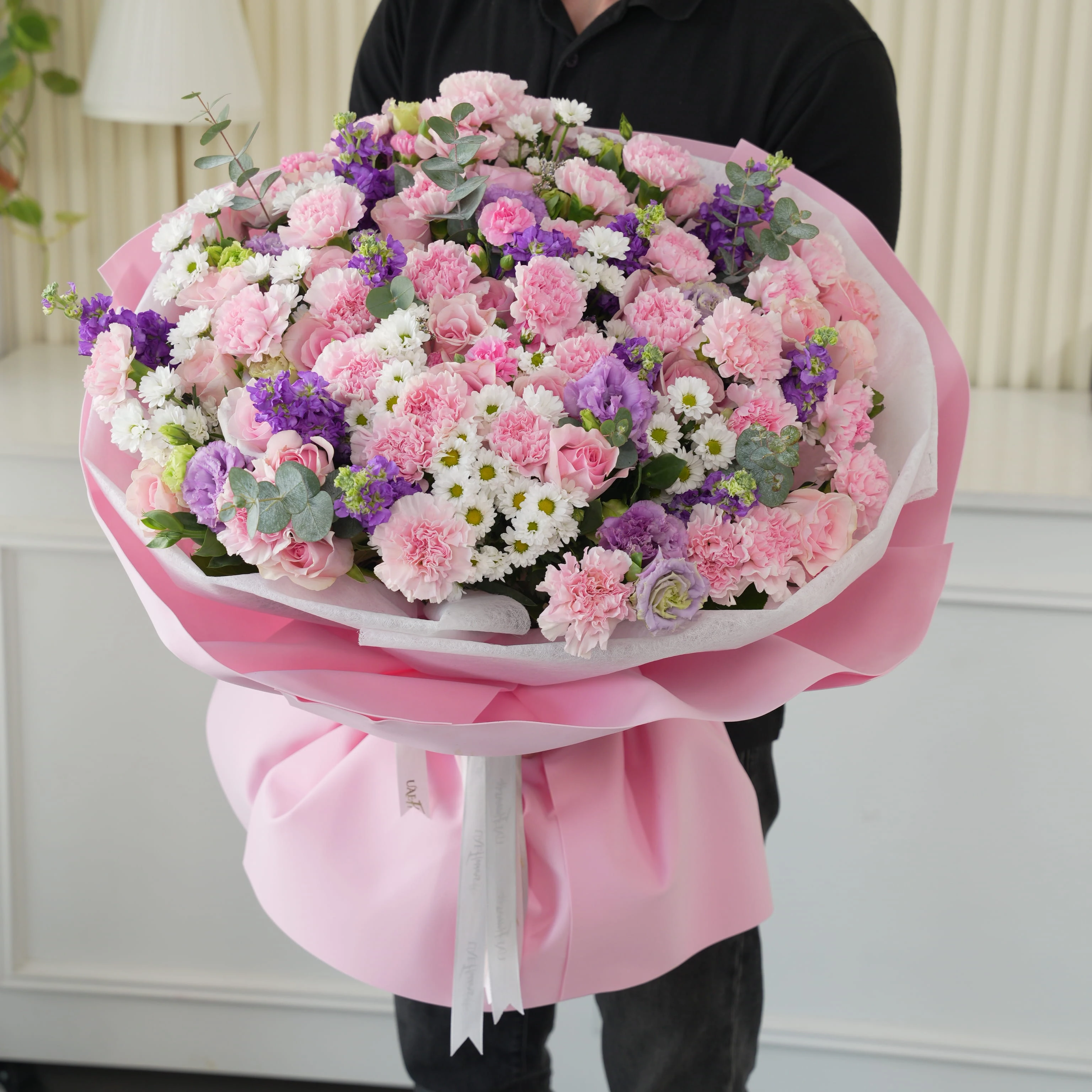 Bouquet of 10 purple matthiola, 10 white chrysanthemums, 10 purple lisianthus, 30 pink carnations and 50 pink roses with green fillers in nice wrapping.
