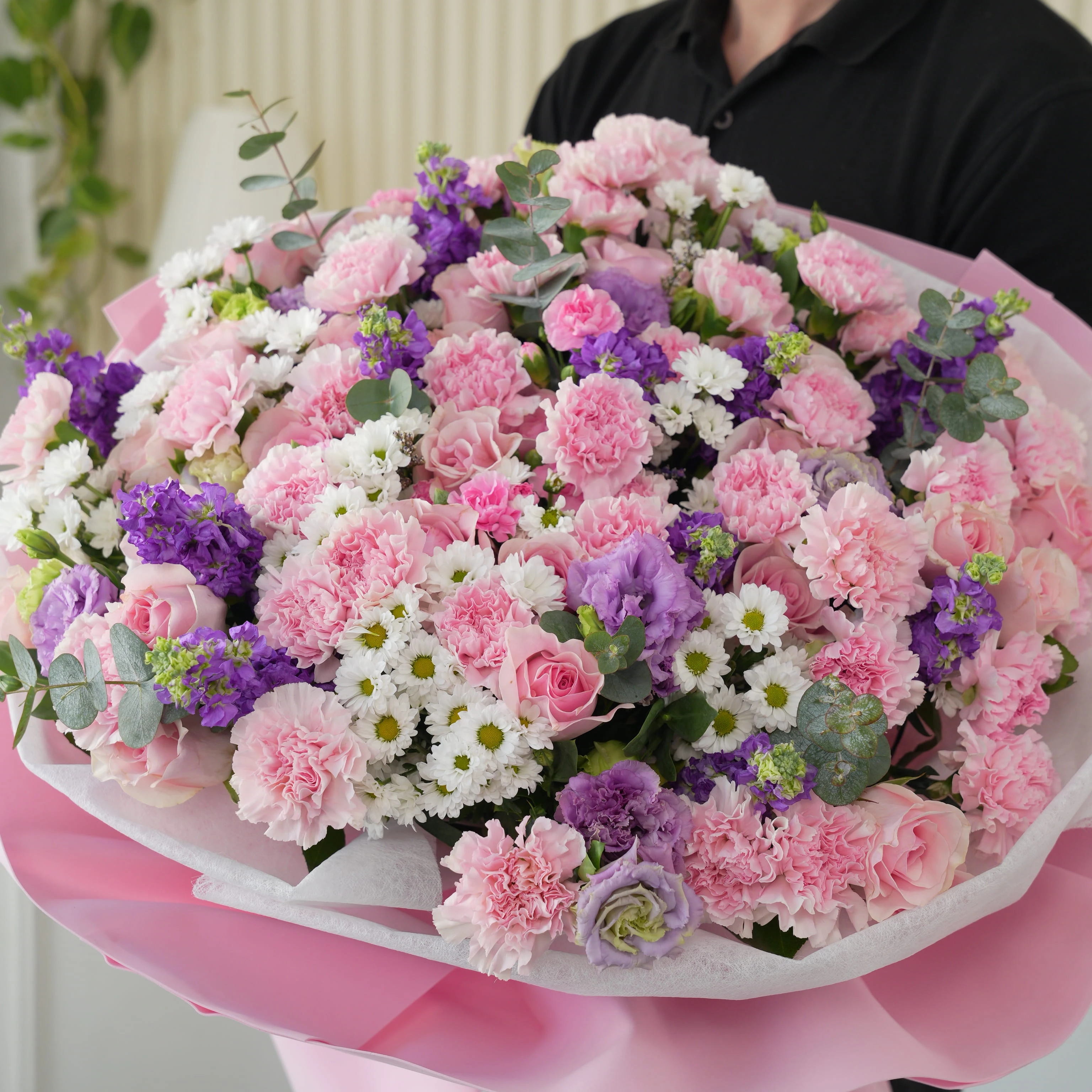 Bouquet of 10 purple matthiola, 10 white chrysanthemums, 10 purple lisianthus, 30 pink carnations and 50 pink roses with green fillers in nice wrapping.