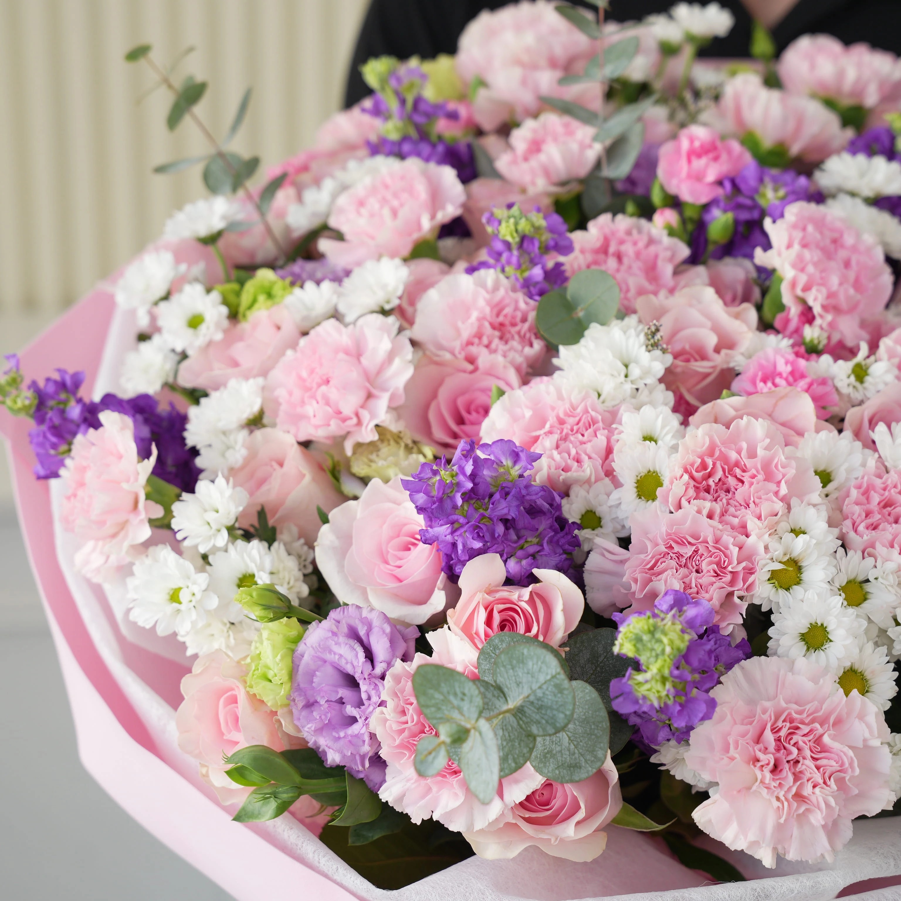 Bouquet of 10 purple matthiola, 10 white chrysanthemums, 10 purple lisianthus, 30 pink carnations and 50 pink roses with green fillers in nice wrapping.