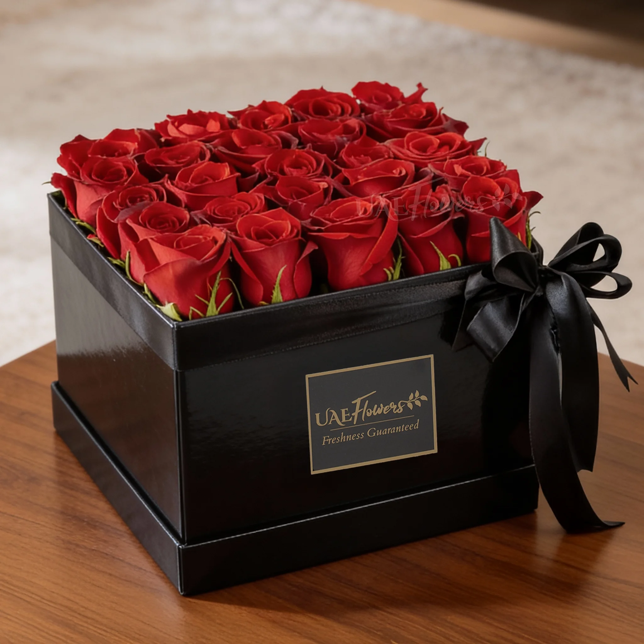 25 red roses in a square box.