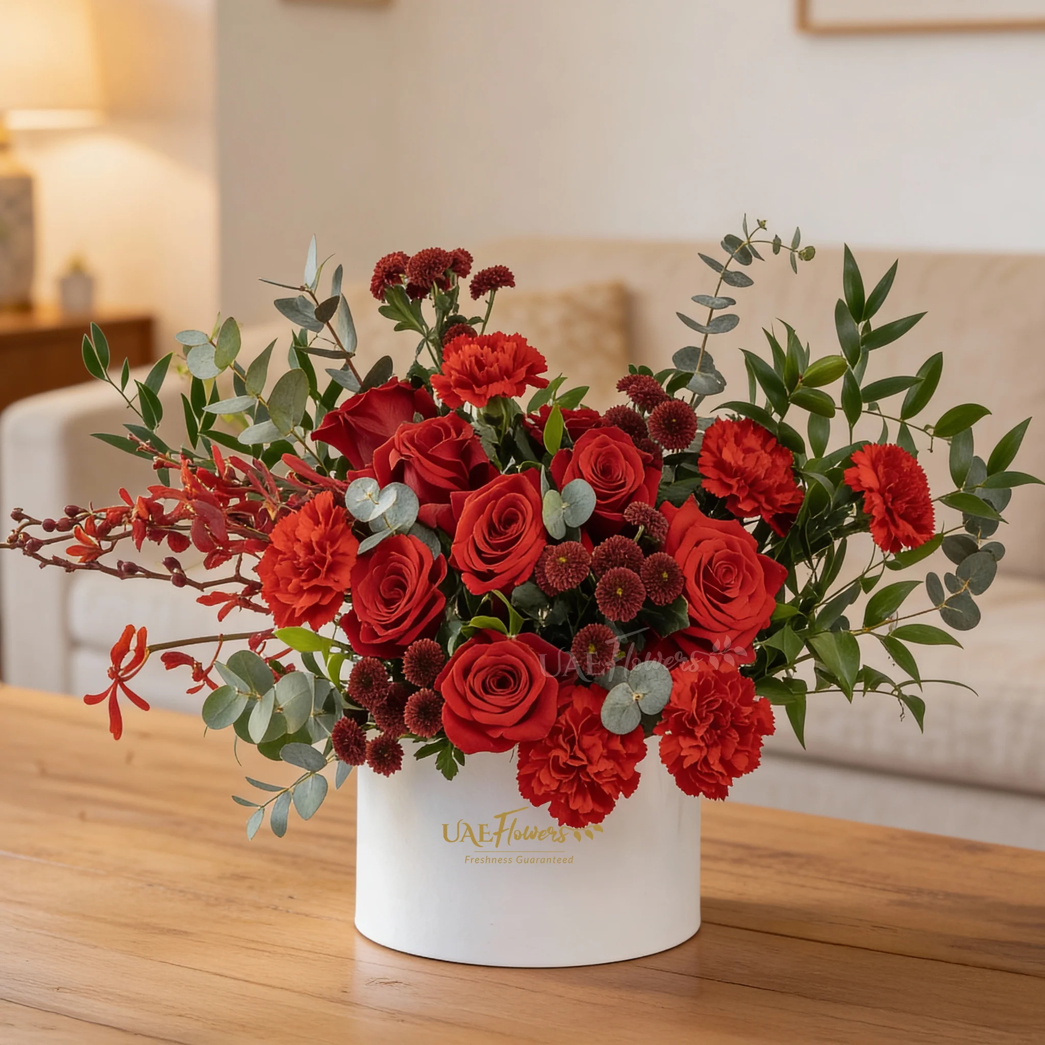 7 red roses, 4 red chrysanthemums, 6 red carnations and 3 annies black orchids with fillers in a round box.