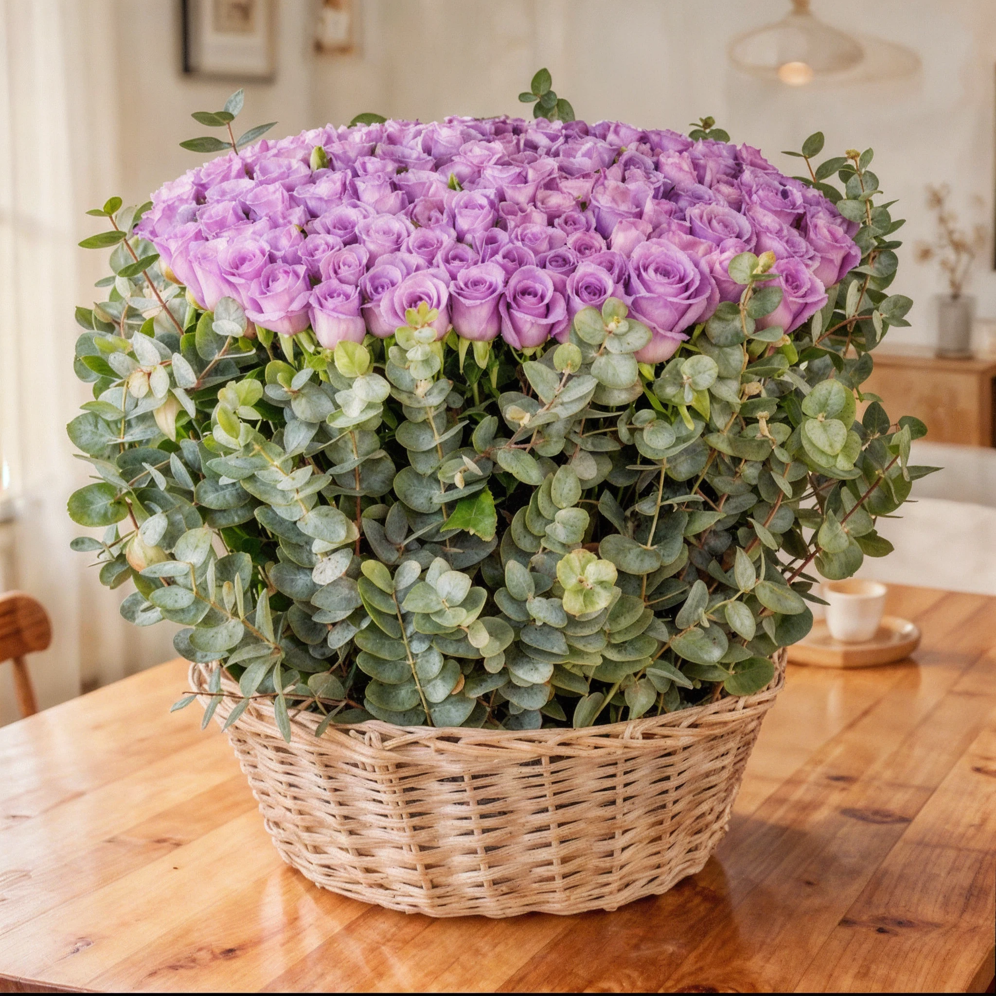 150 purple roses with eucalyptus leaf in a basket.