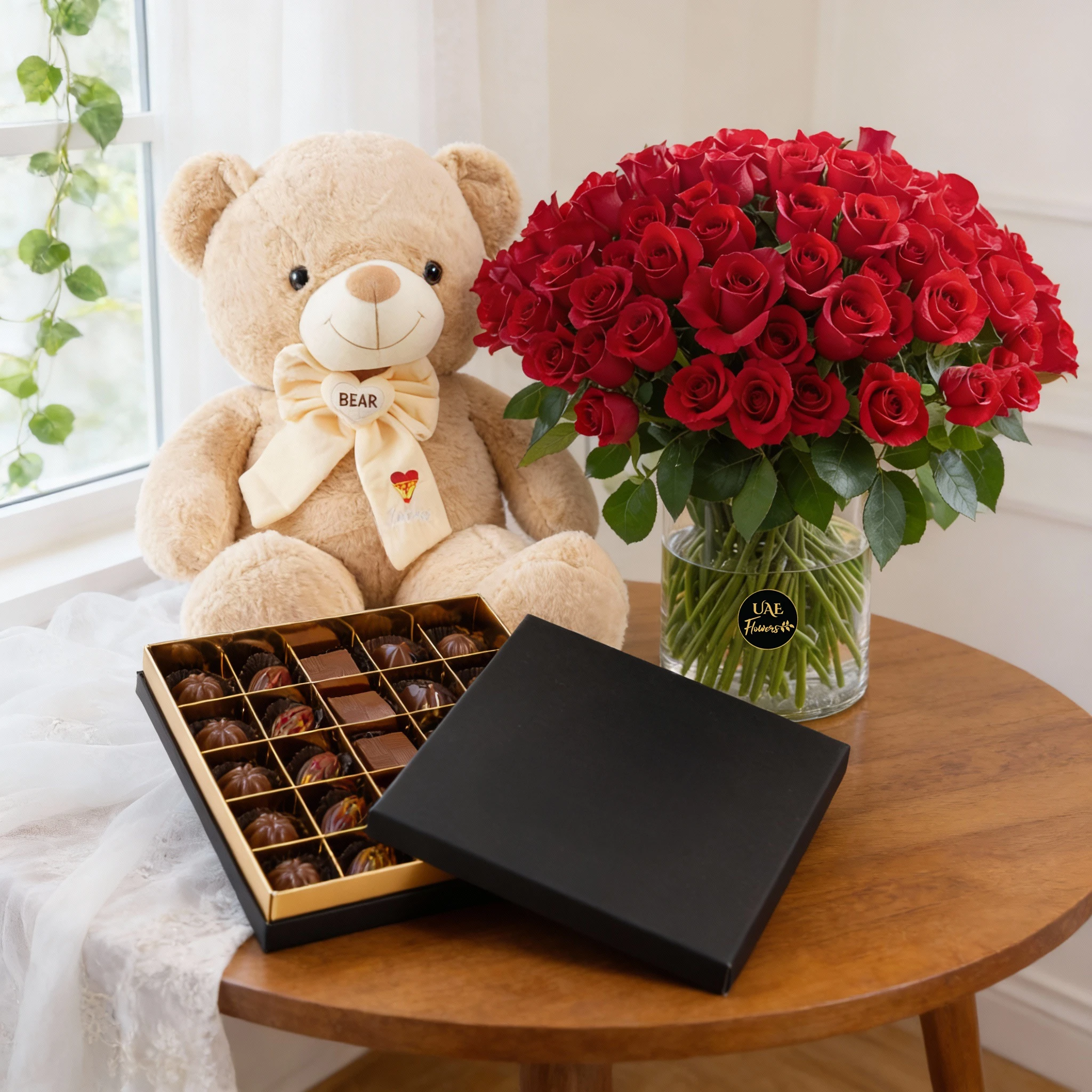 100 red roses with green fillers in glass vase, 130CM teddy bear and 25 Pcs Pistache Signature Temptation Chocolate Box.