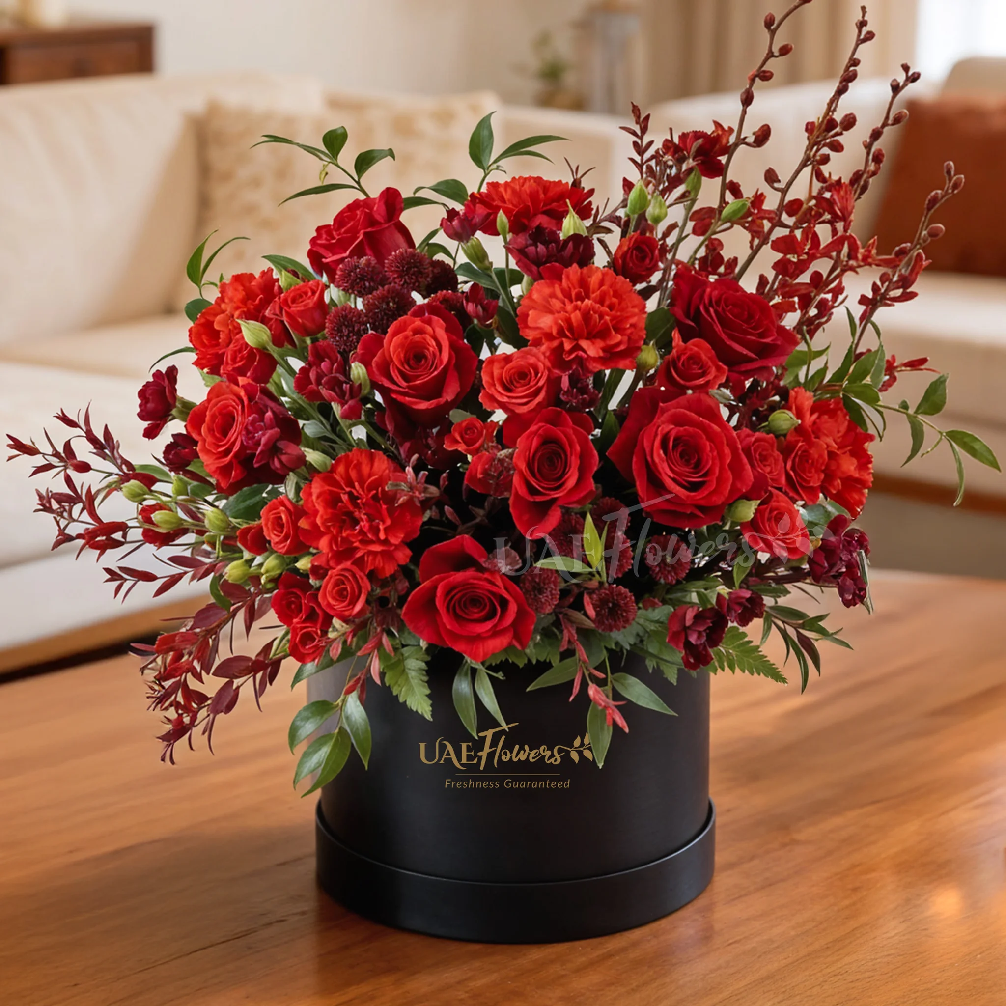 4 annie black orchids, 8 red roses, 3 red spray roses, 2 red chrysanthemums and 4 red spray carnations with green fillers in a round box.