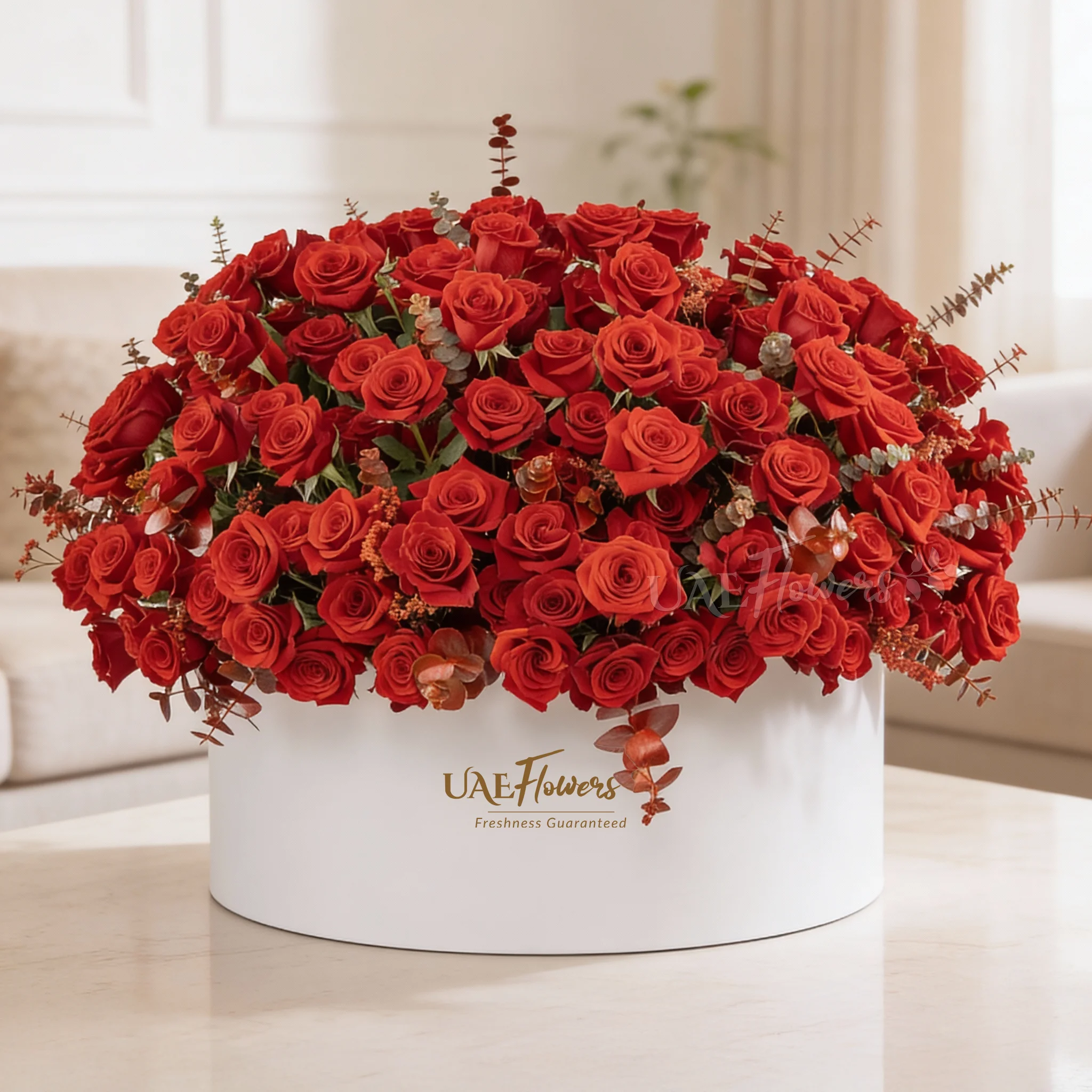 Full round arrangement of 250 red roses in a white round box.