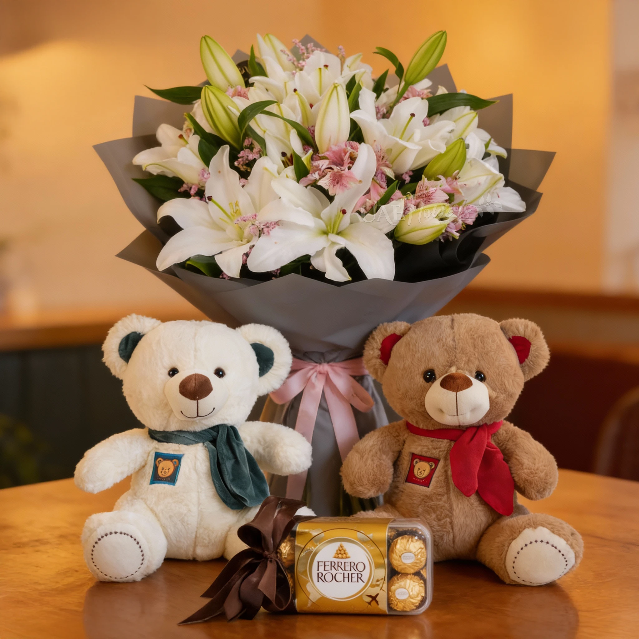 Bouquet of 5 white lilies and pink alstroemeria with green fillers in nice wrapping, small pink and brown teddy bear and 16pcs of Ferrero rocher chocolate.