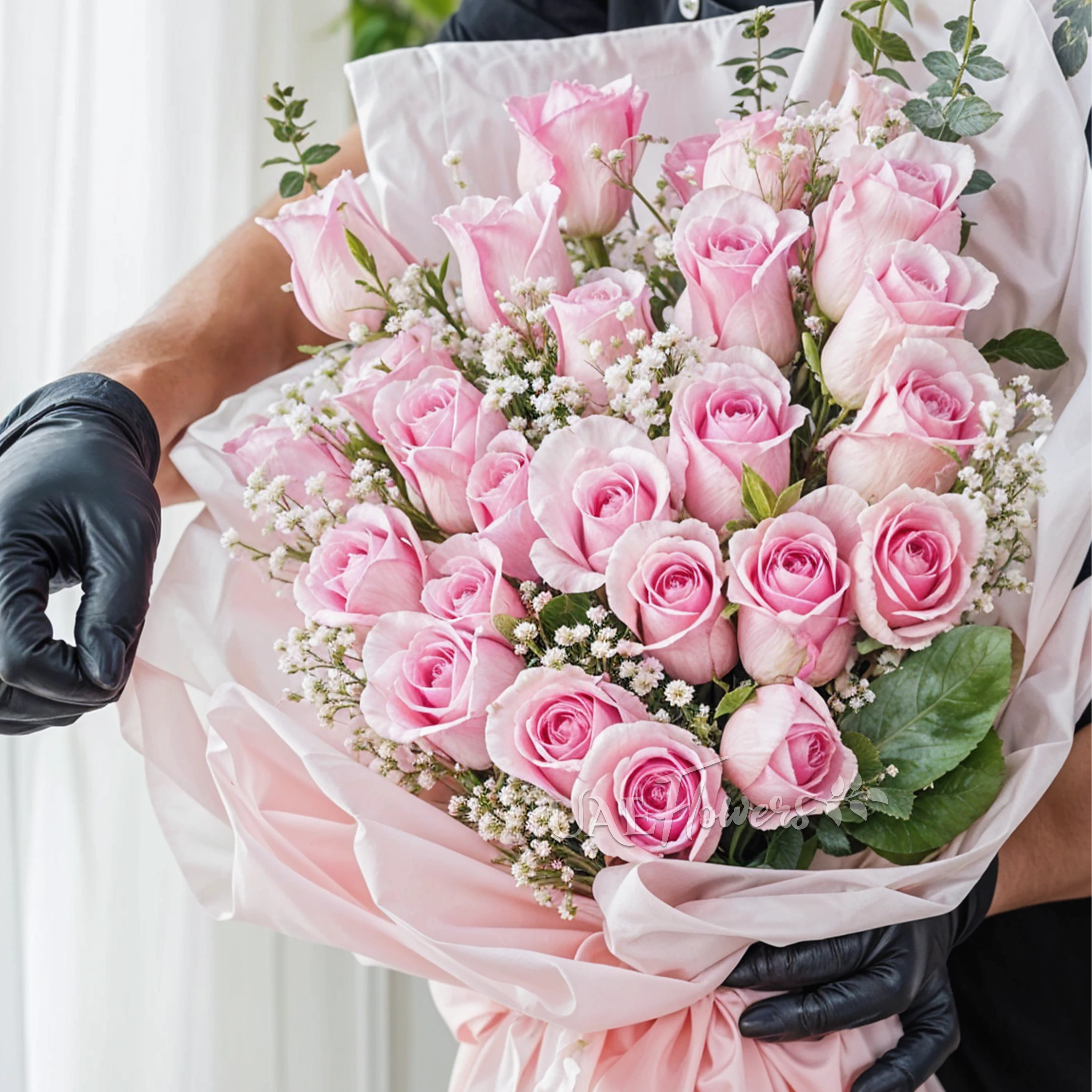 Bouquet of 24 pink roses with baby's breath & green fillers in a pink wrapping paper.