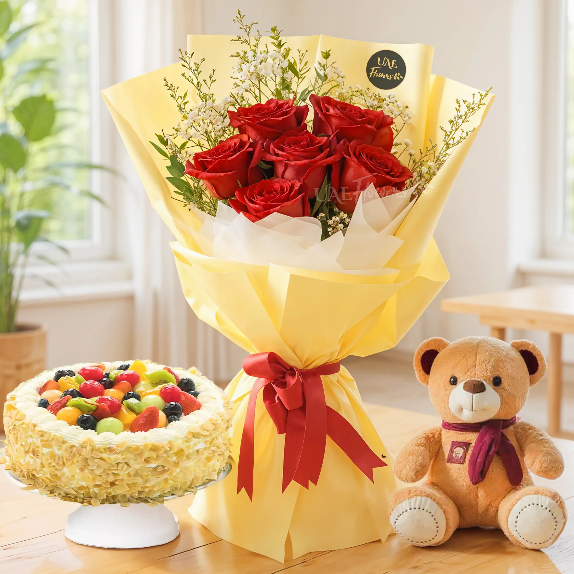 Bouquet of 6 red roses with green fillers in nice paper packing with ribbons, 1 kg fruit cake and a small brown teddy bear.