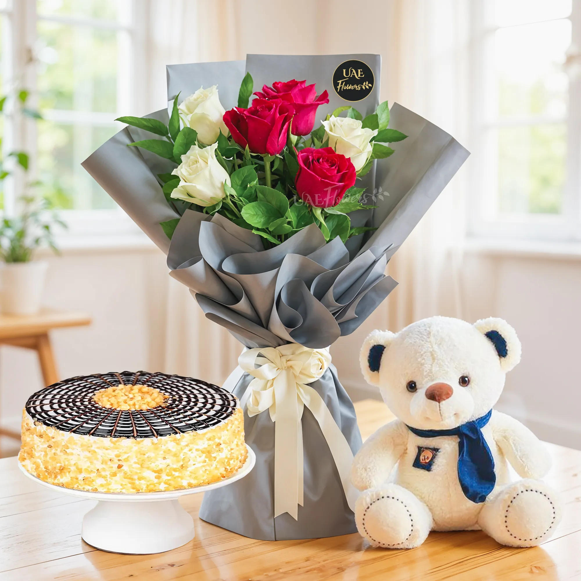 Bouquet of 6 red & white roses with green fillers in nice paper packing with ribbons, 1 kg butterscotch cake and a small white teddy bear.