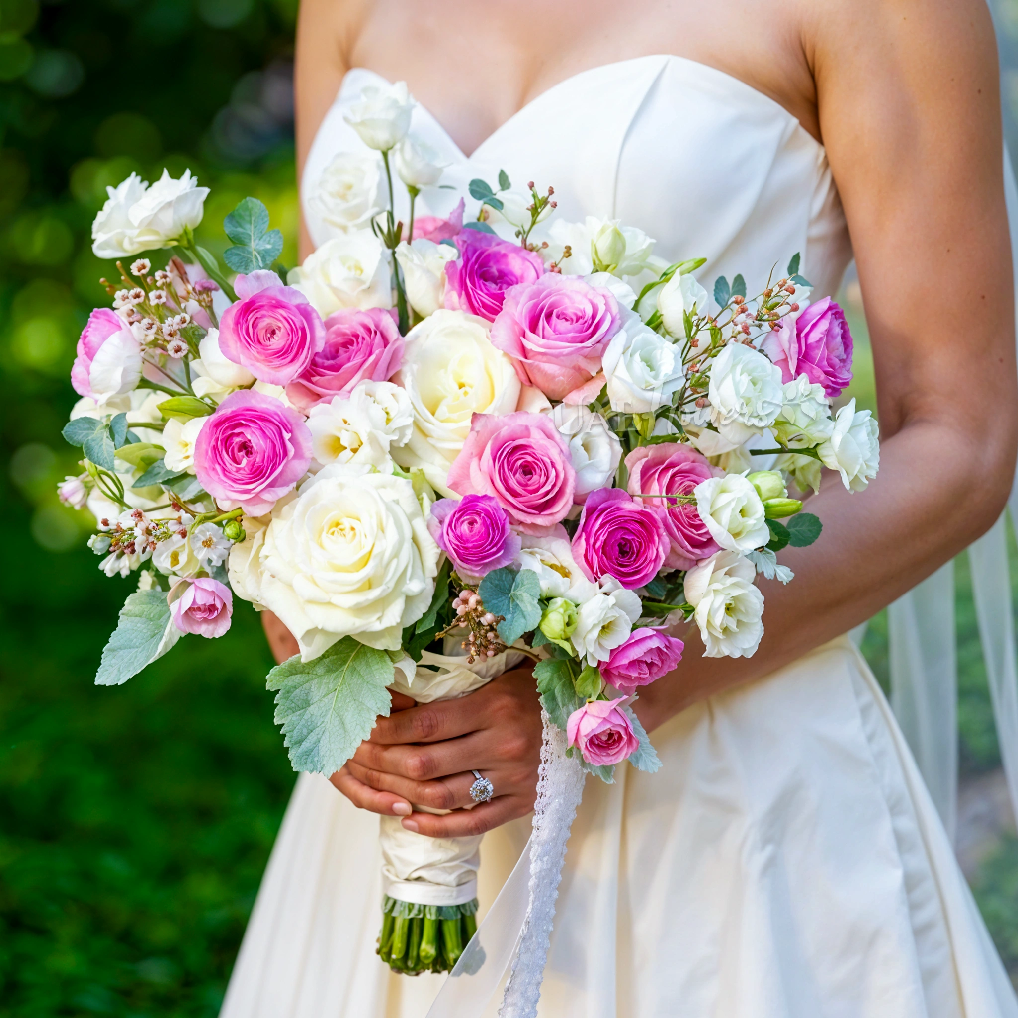 Bridal hand-tied bouquet of 10 white lisianthus, 5 pink ranunculus, 12 pink and white roses and wax flowers with greens.