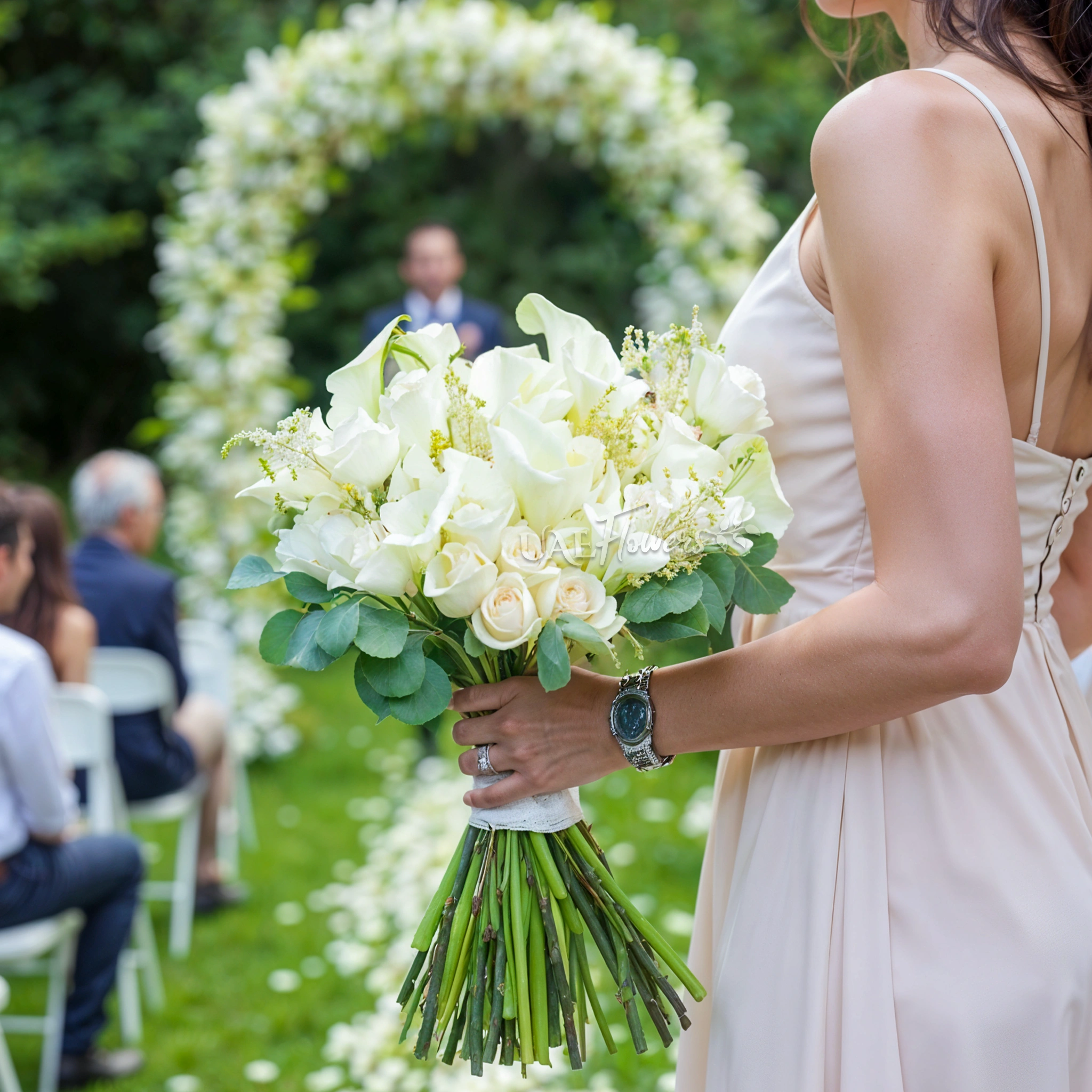 Bridal hand-tied bouquet of 20 white calla lilies and 15 white roses with greens.