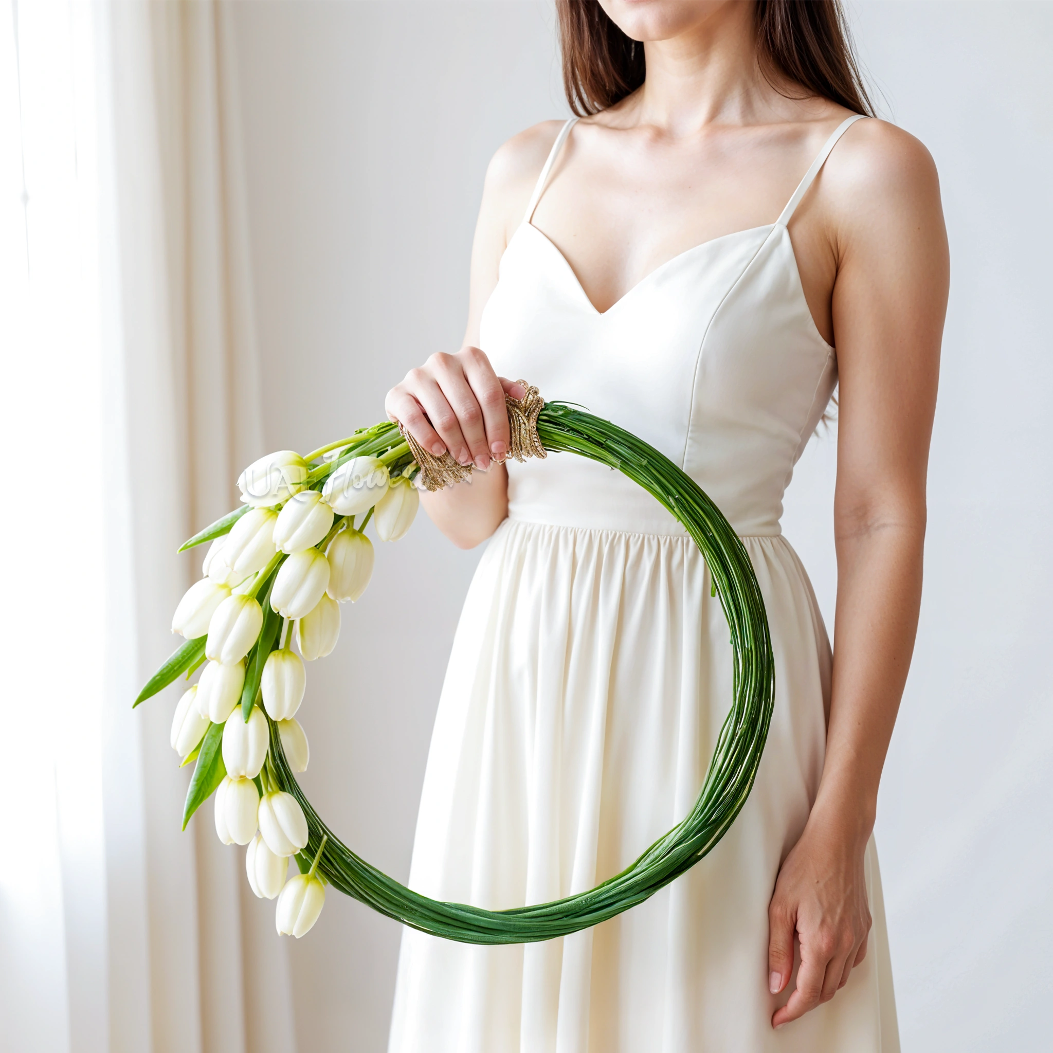 Bridal hand-tied round arrangement of 30 white tulips and 3 bundles of steel grass.