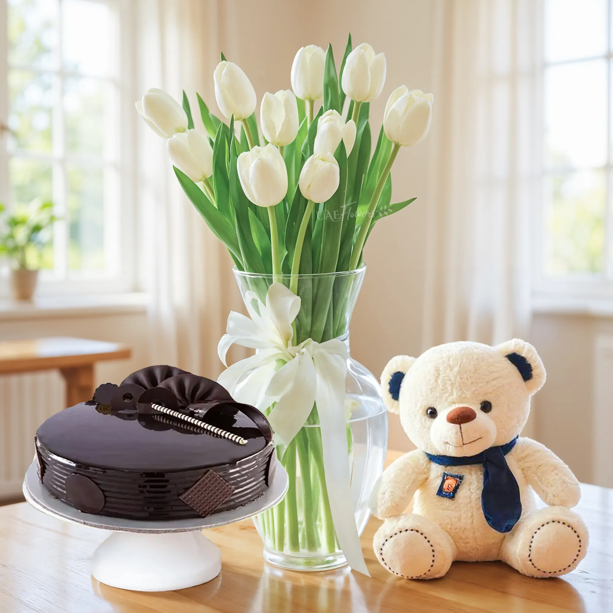 10 white tulips in a glass vase, 1 kg chocolate cake and a small white teddy bear.