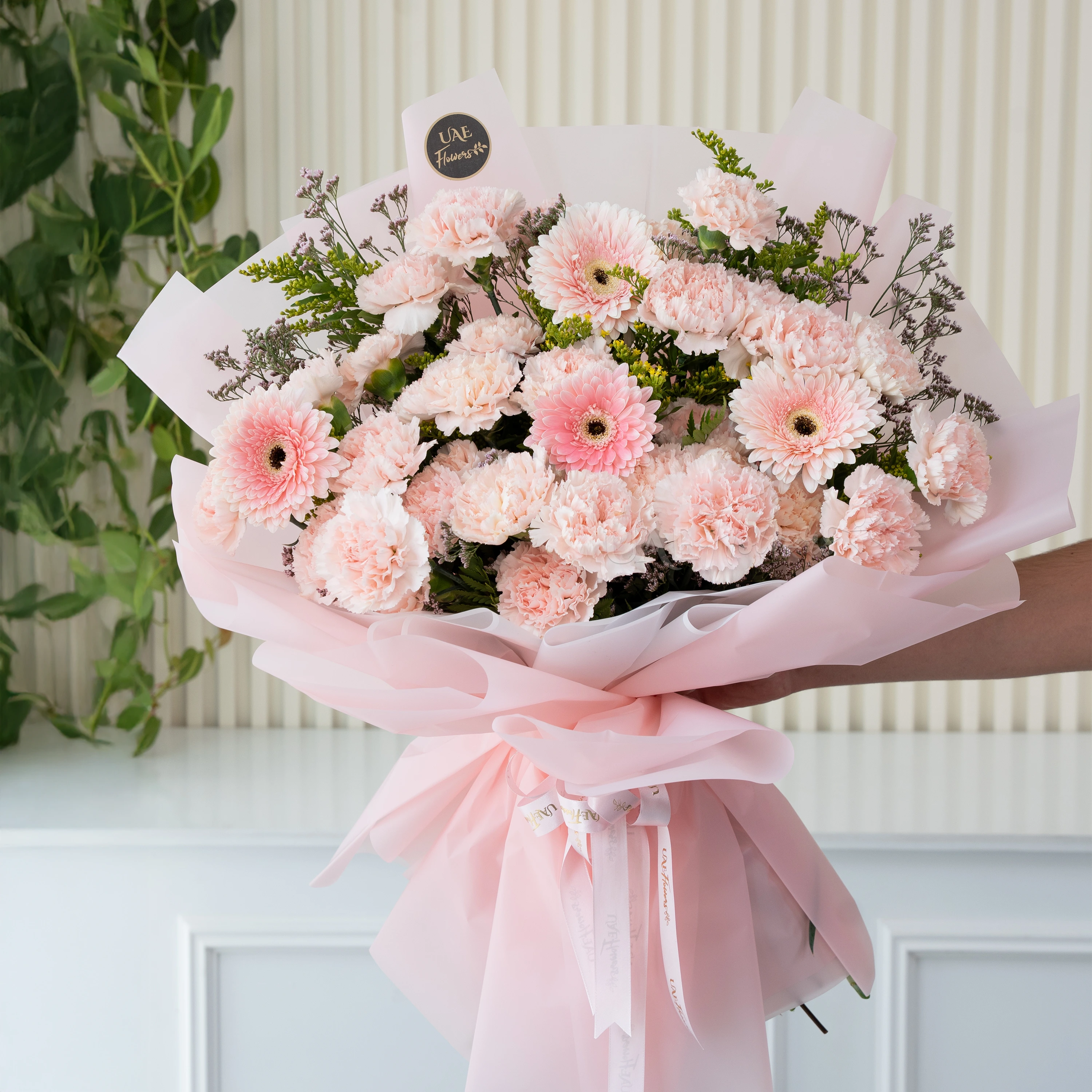 25 pink carnations, 4 pink gerberas wrapped in pink with solidago and limonium fillers.