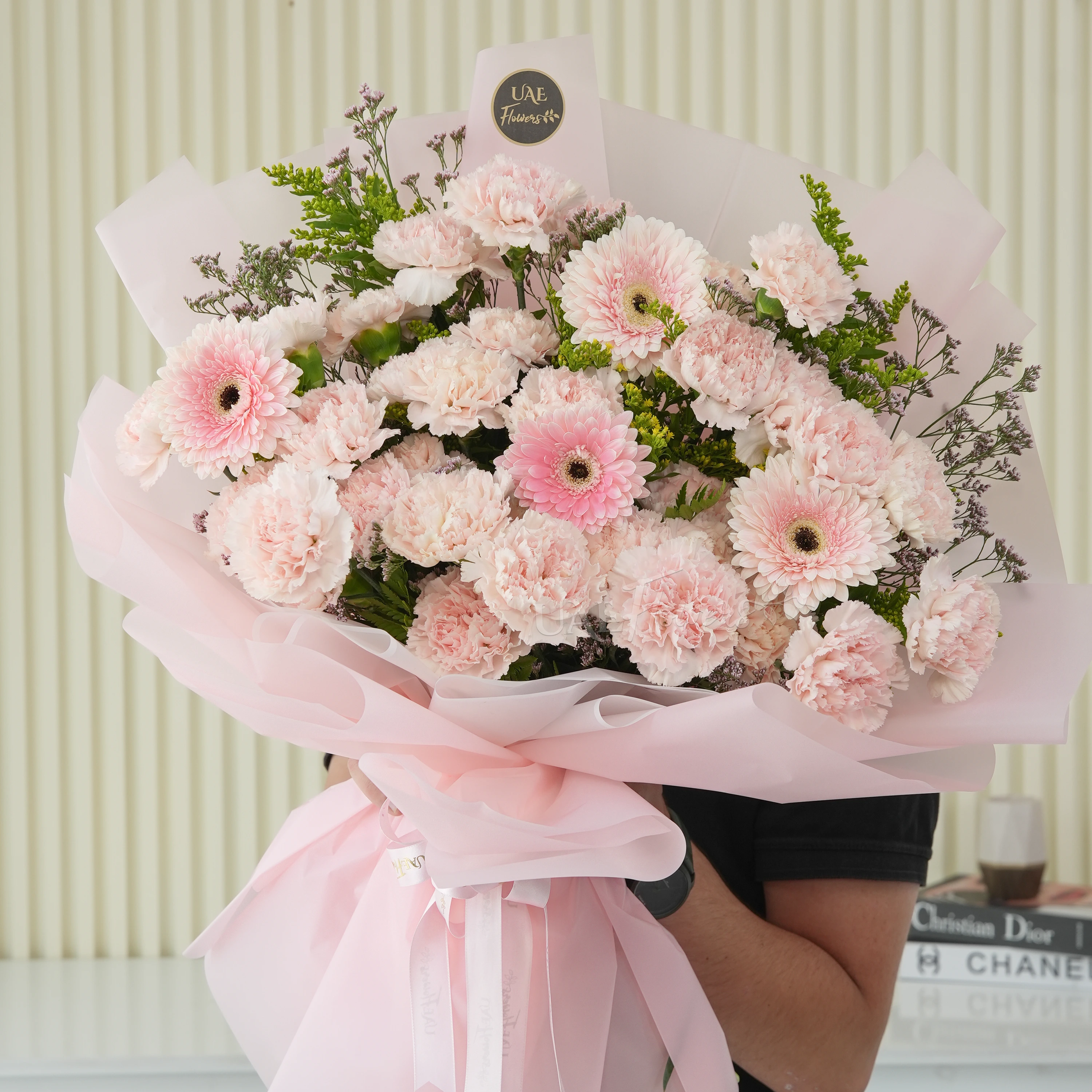 25 pink carnations, 4 pink gerberas wrapped in pink with solidago and limonium fillers.