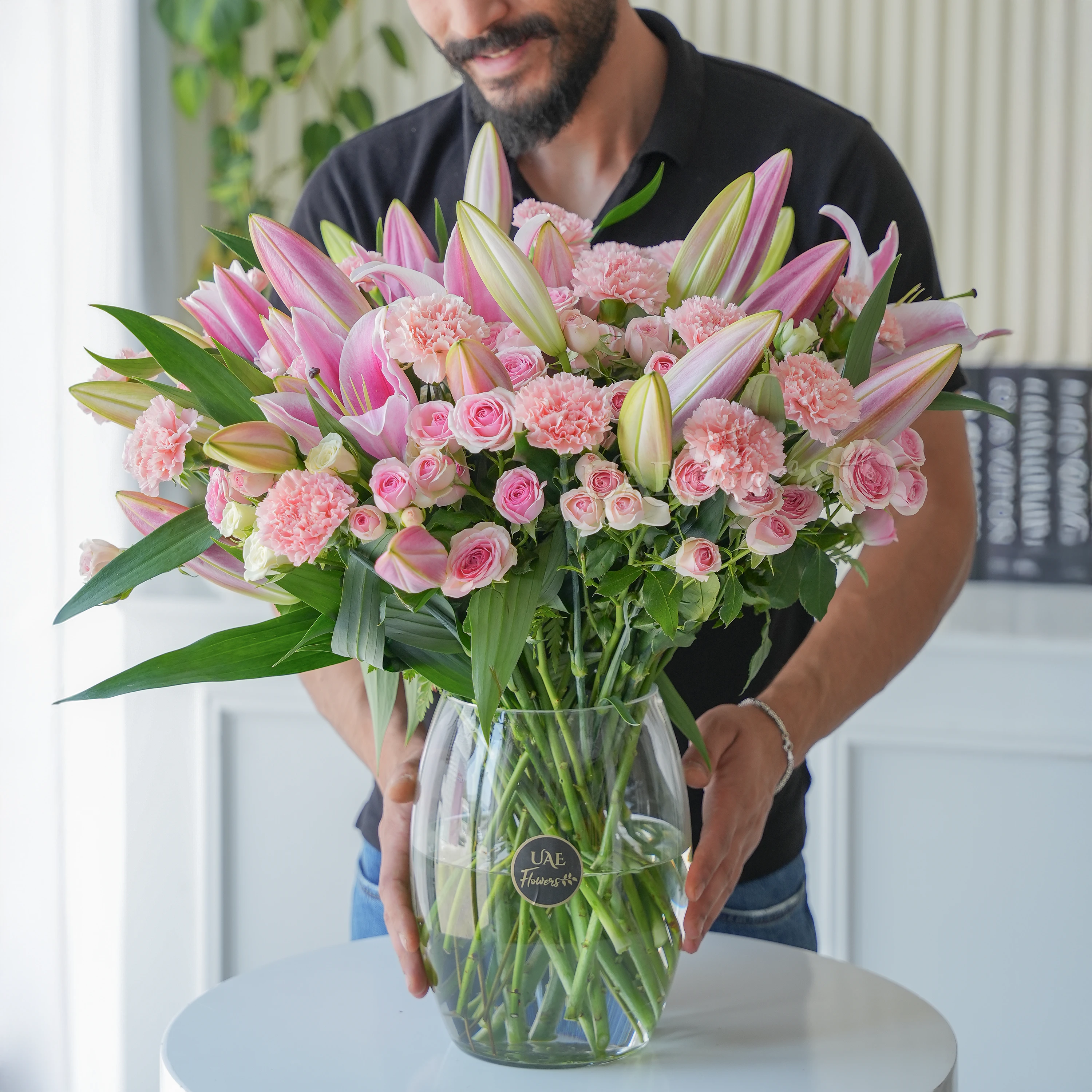 5 Pink Lilies, 15 carnations, 15 spray roses and fillers in a vase.
