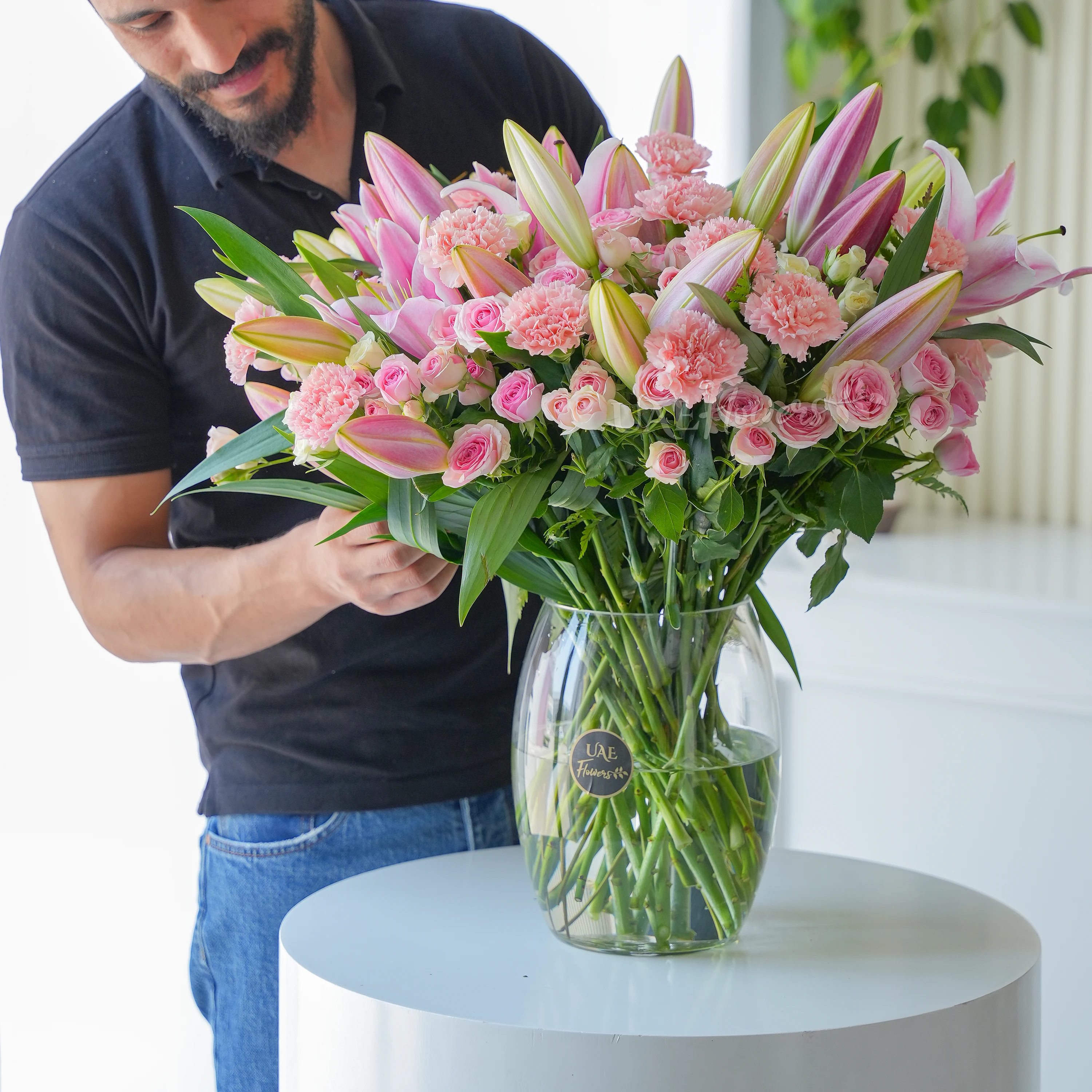 5 Pink Lilies, 15 carnations, 15 spray roses and fillers in a vase.