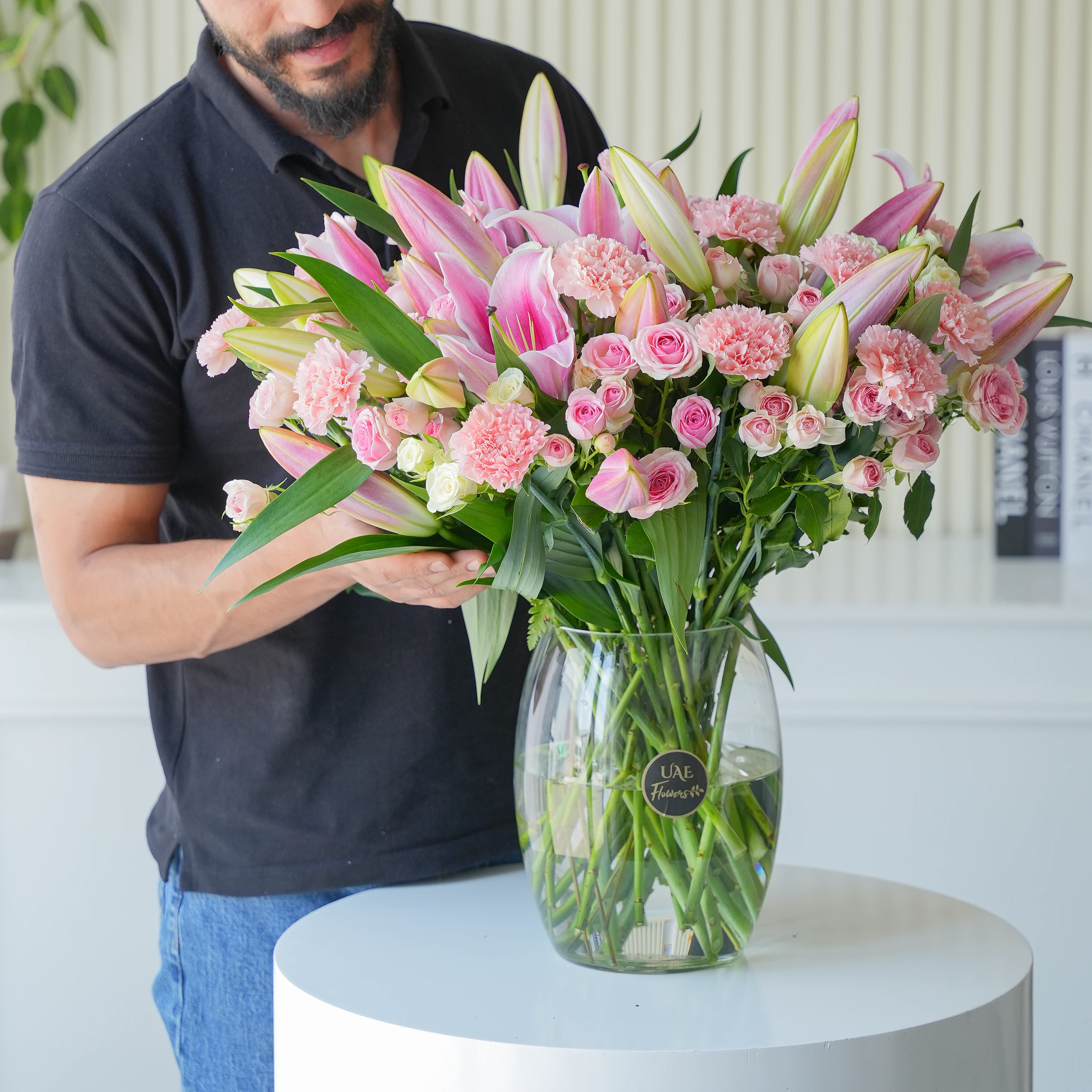 5 Pink Lilies, 15 carnations, 15 spray roses and fillers in a vase.