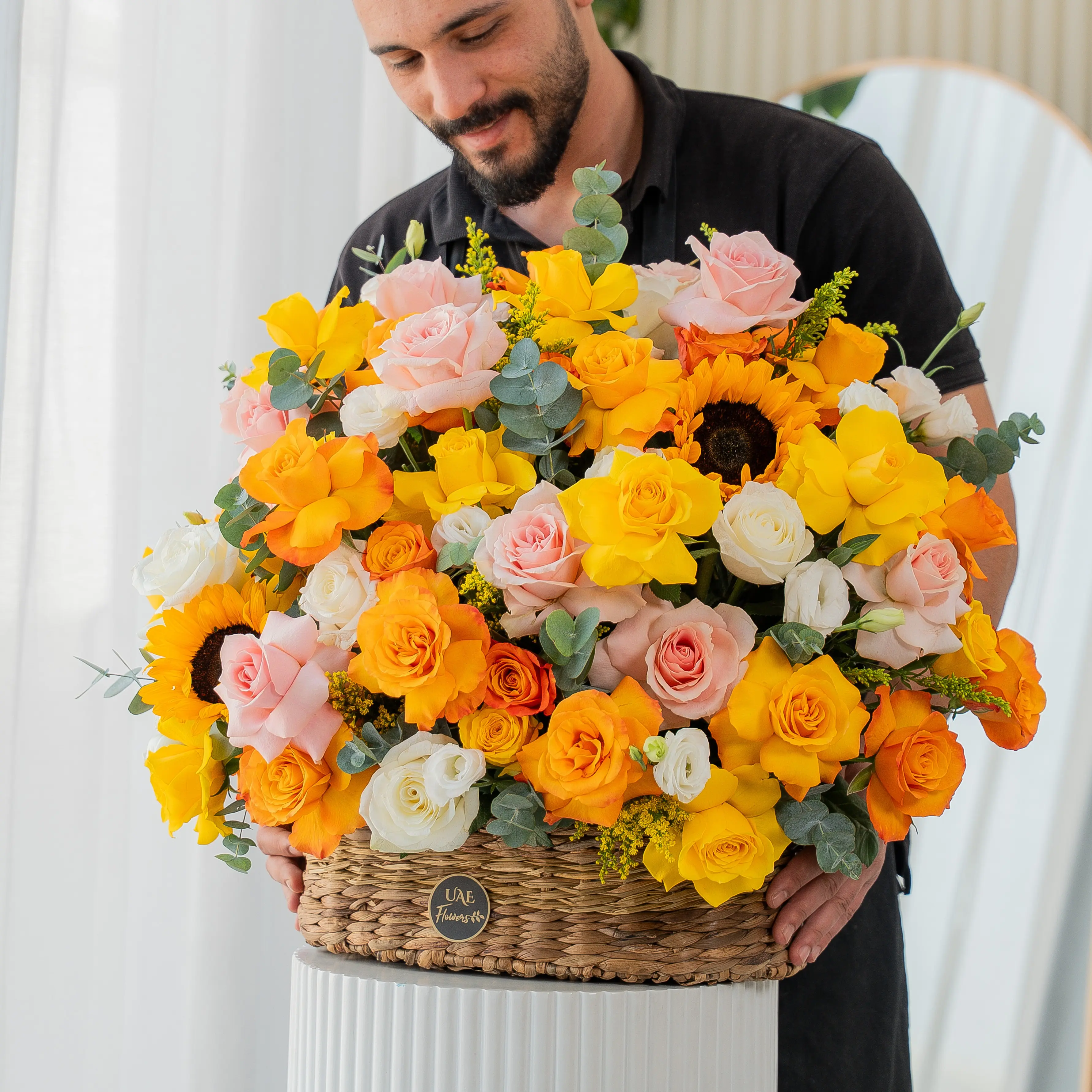 Yellow, peach, and orange roses with sunflowers in basket for Diwali by UAE Flowers Dubai