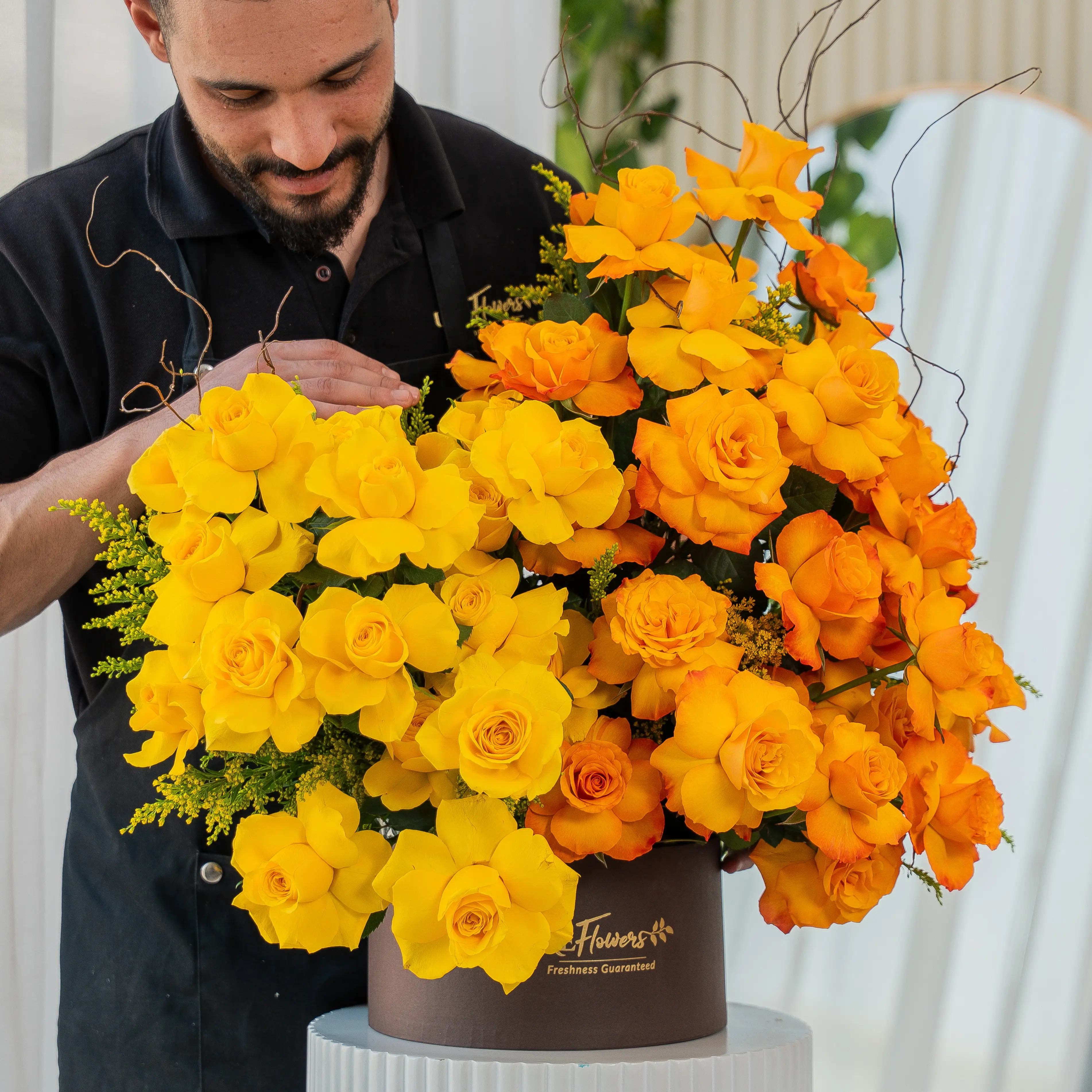 Yellow and orange roses in luxury hatbox for Diwali by UAE Flowers Dubai
