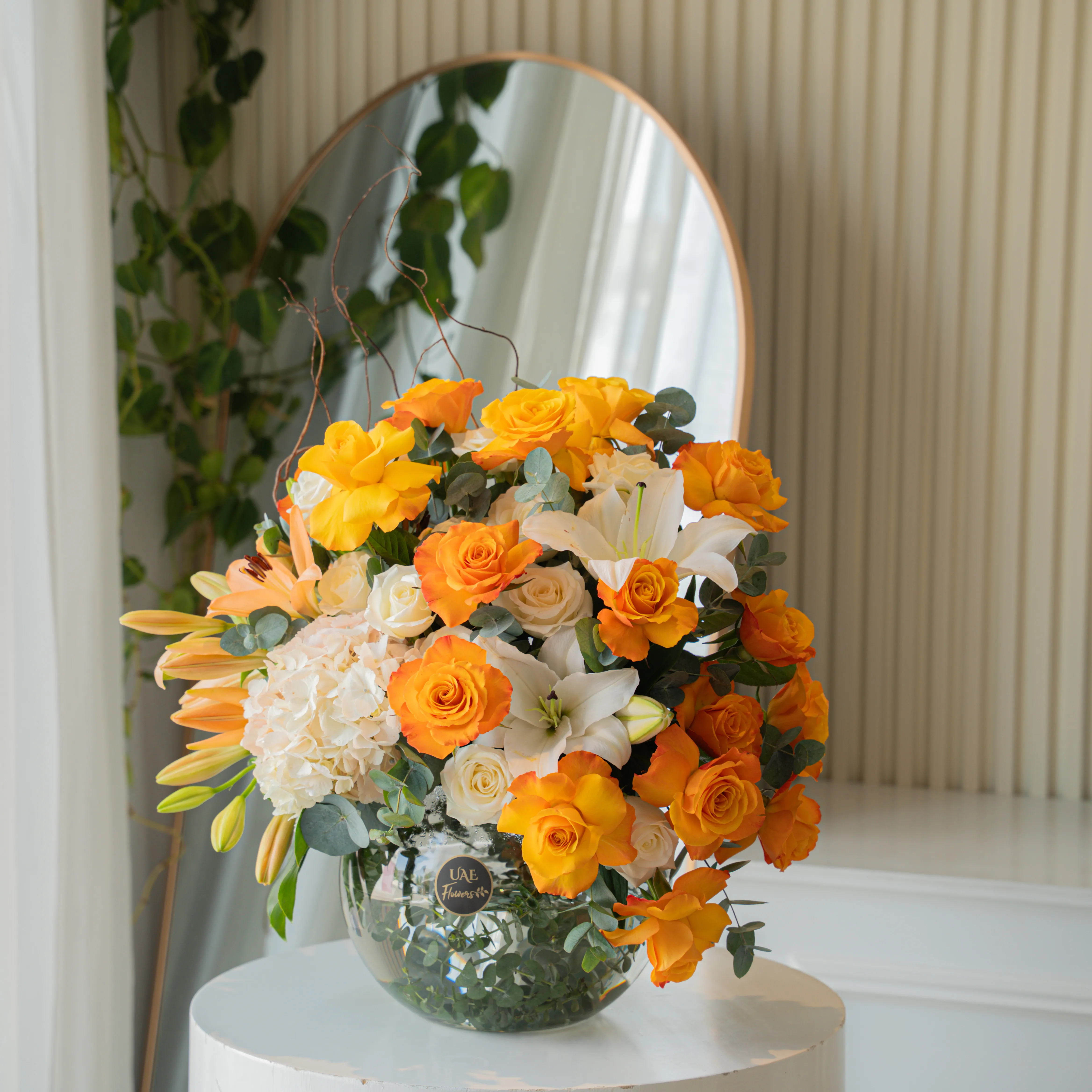 Orange roses, white lilies, and hydrangeas in glass vase for Diwali by UAE Flowers Dubai