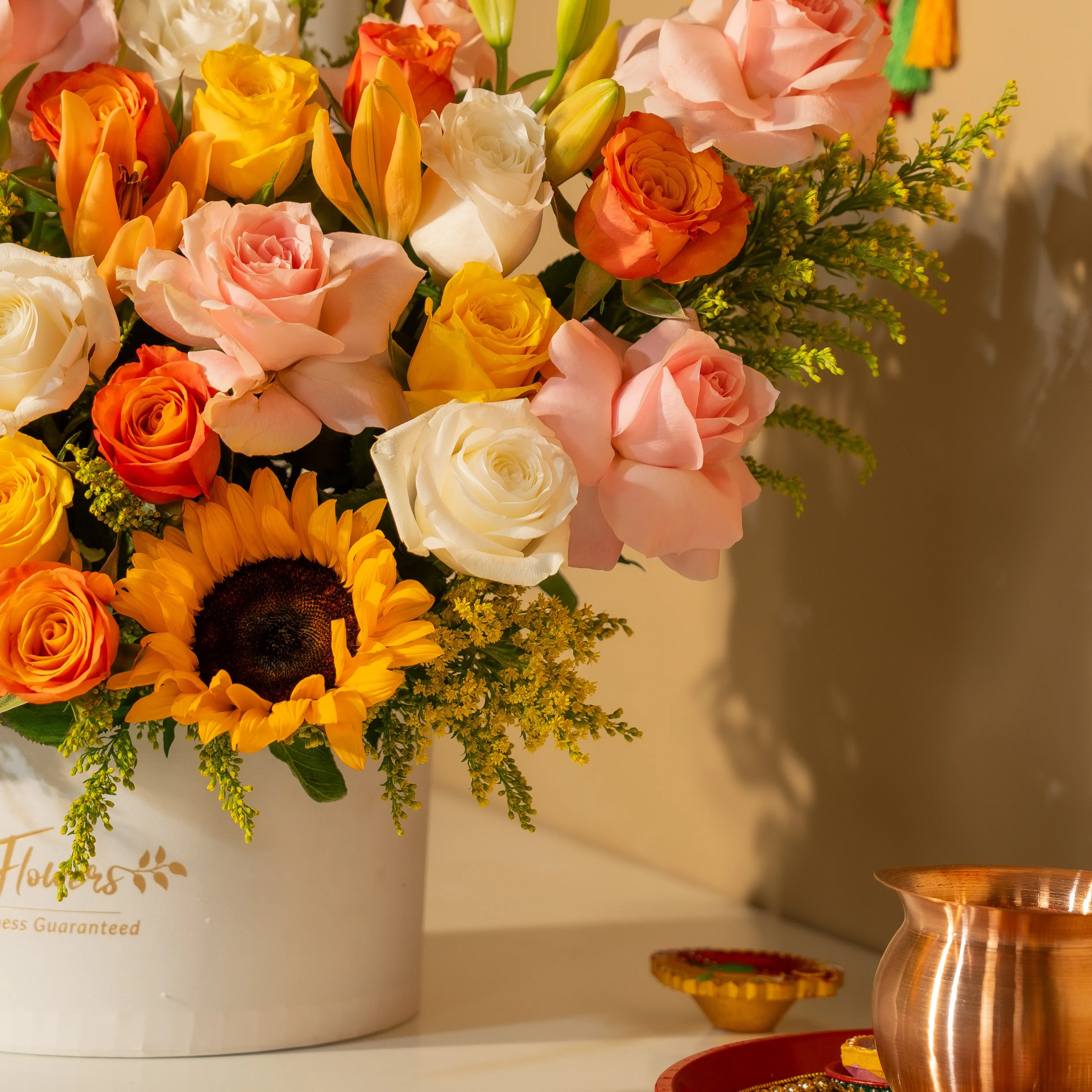 Sunflowers, lilies, and roses in a luxury white hatbox for Diwali by UAE Flowers Dubai