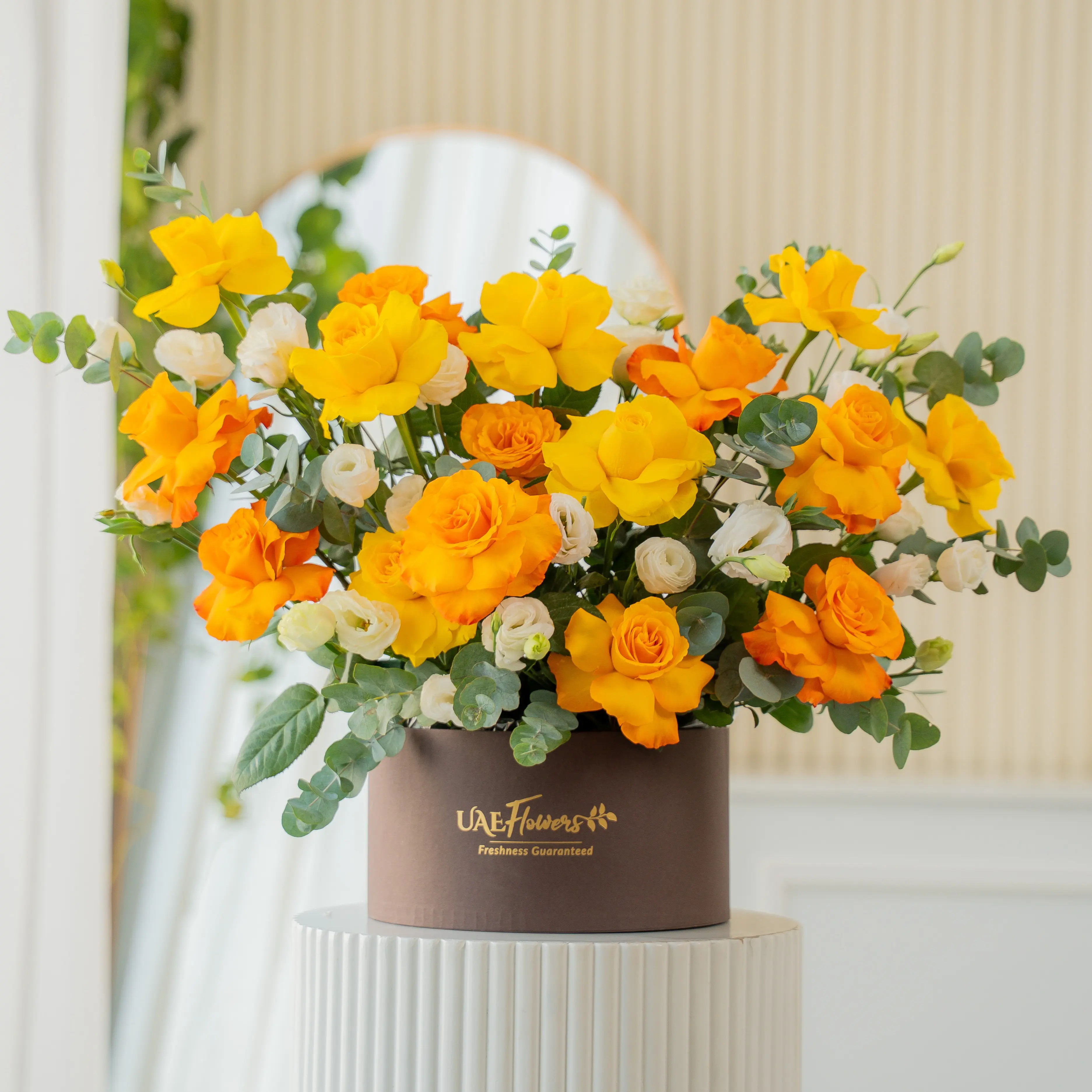 Yellow, orange, and white roses in luxury hatbox for Diwali by UAE Flowers Dubai