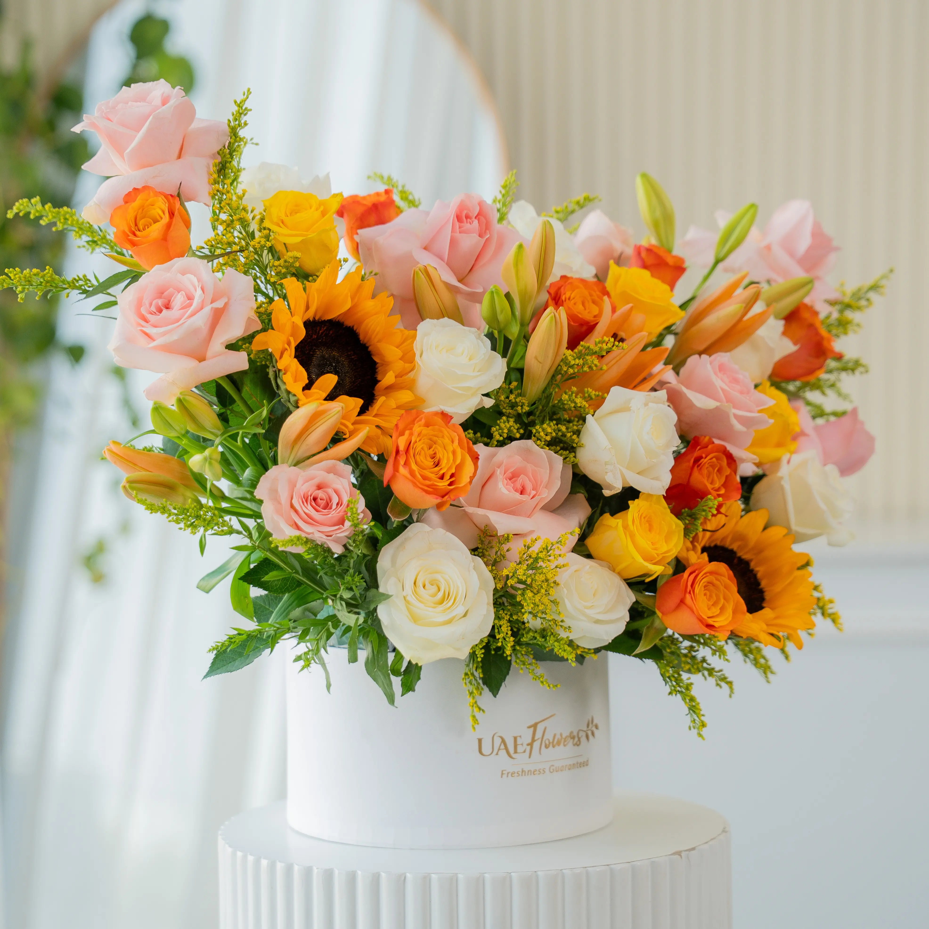 Sunflowers, lilies, and roses in a luxury white hatbox for Diwali by UAE Flowers Dubai