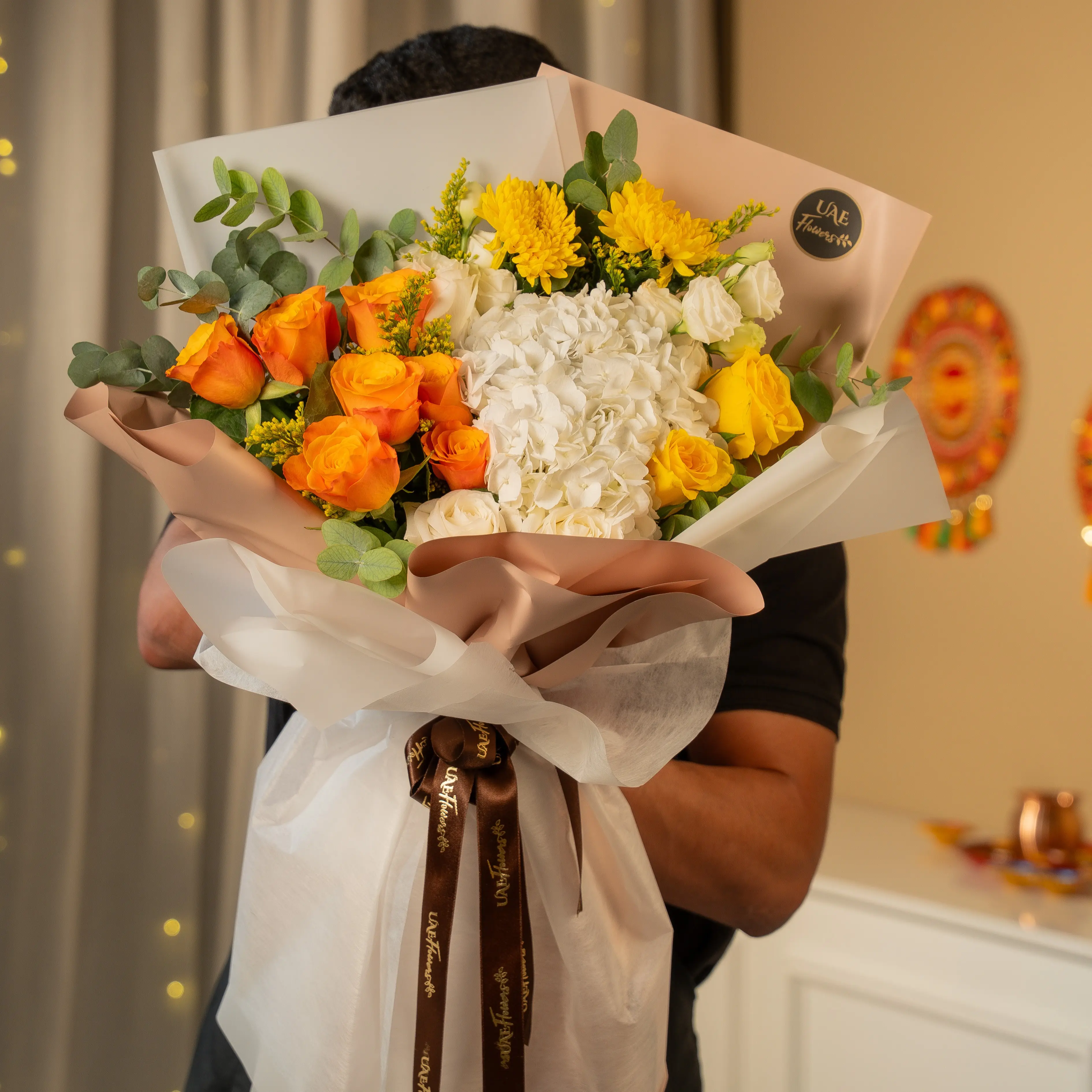 Orange, yellow, and white flower bouquet wrapped in elegant paper for Diwali by UAE Flowers Dubai
