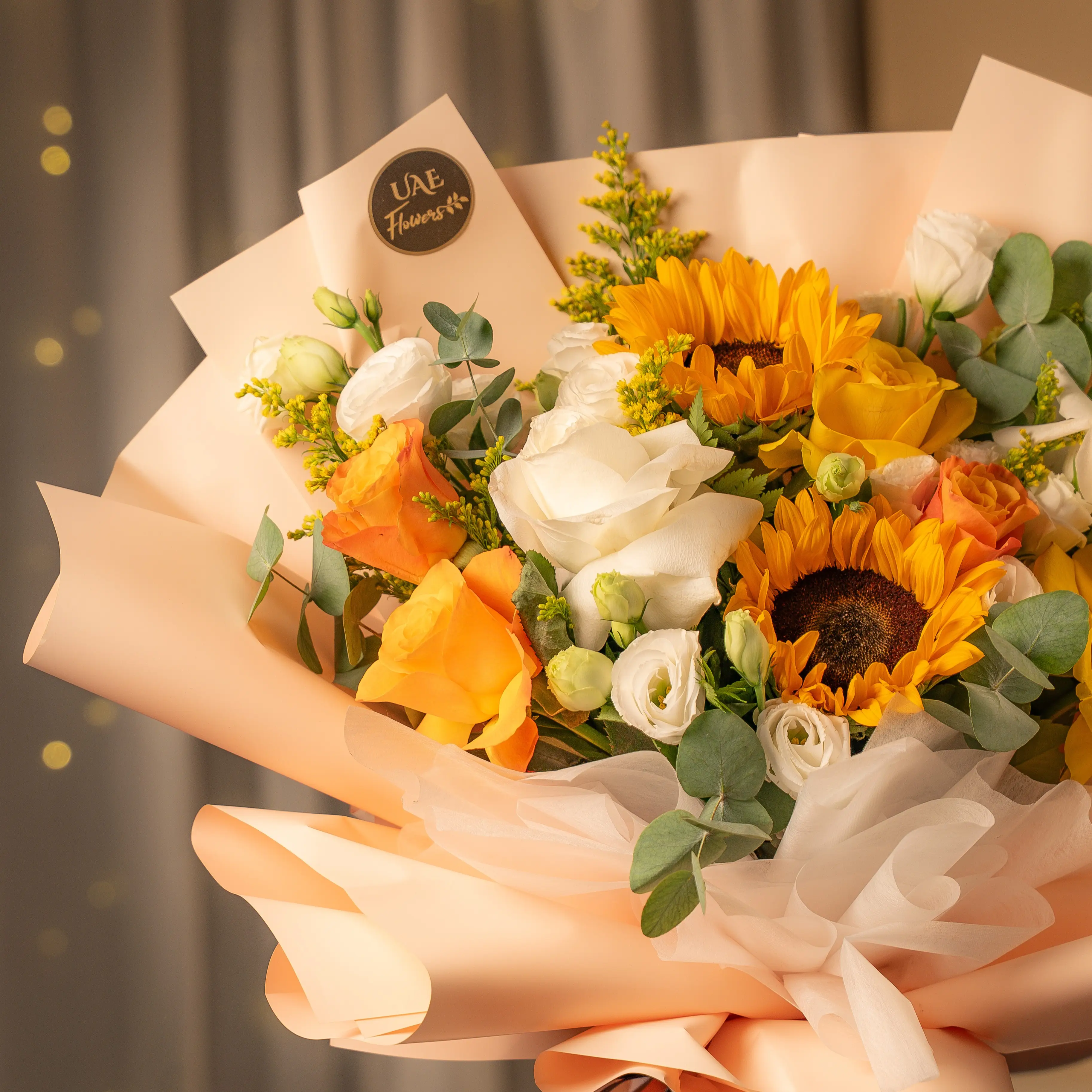 Sunflowers, yellow and white roses bouquet wrapped for Diwali by UAE Flowers Dubai