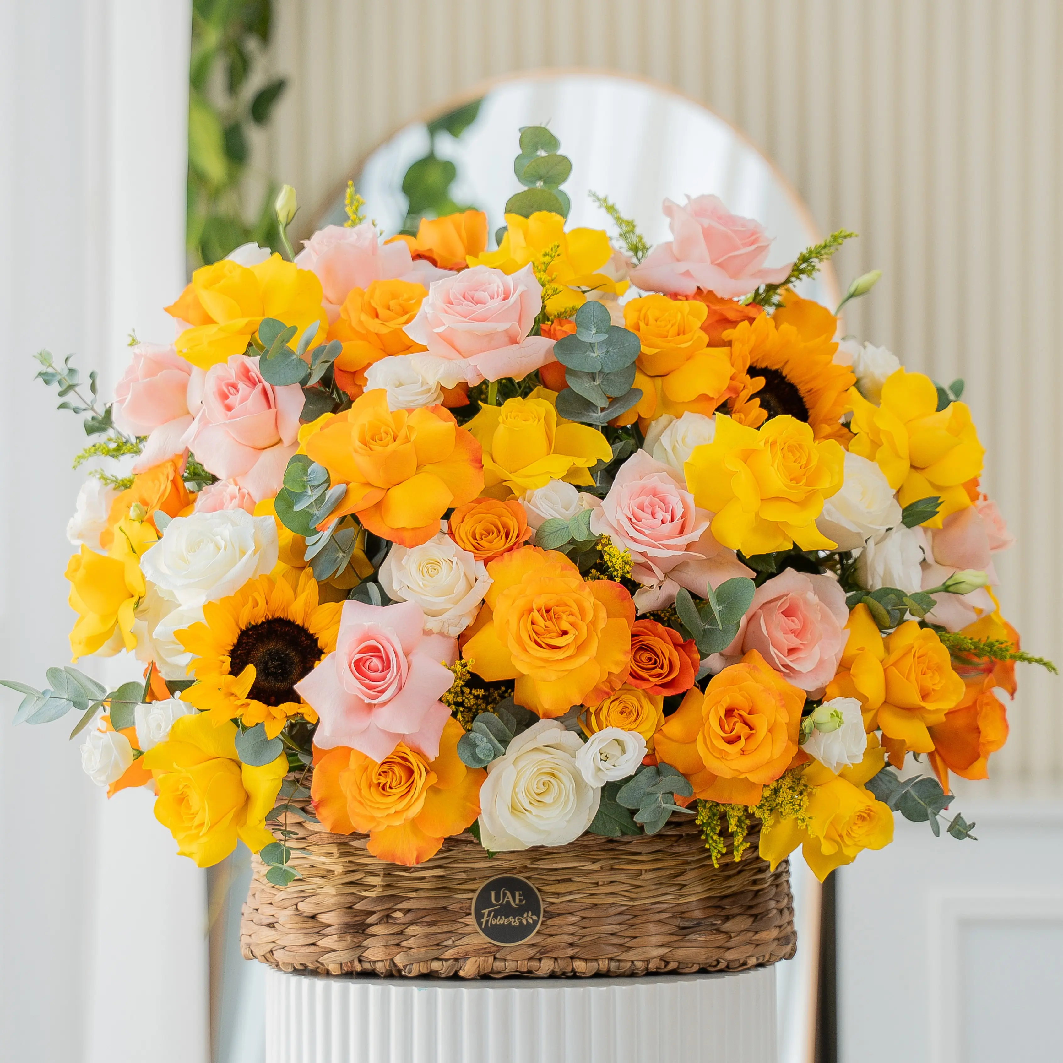 Yellow, peach, and orange roses with sunflowers in basket for Diwali by UAE Flowers Dubai