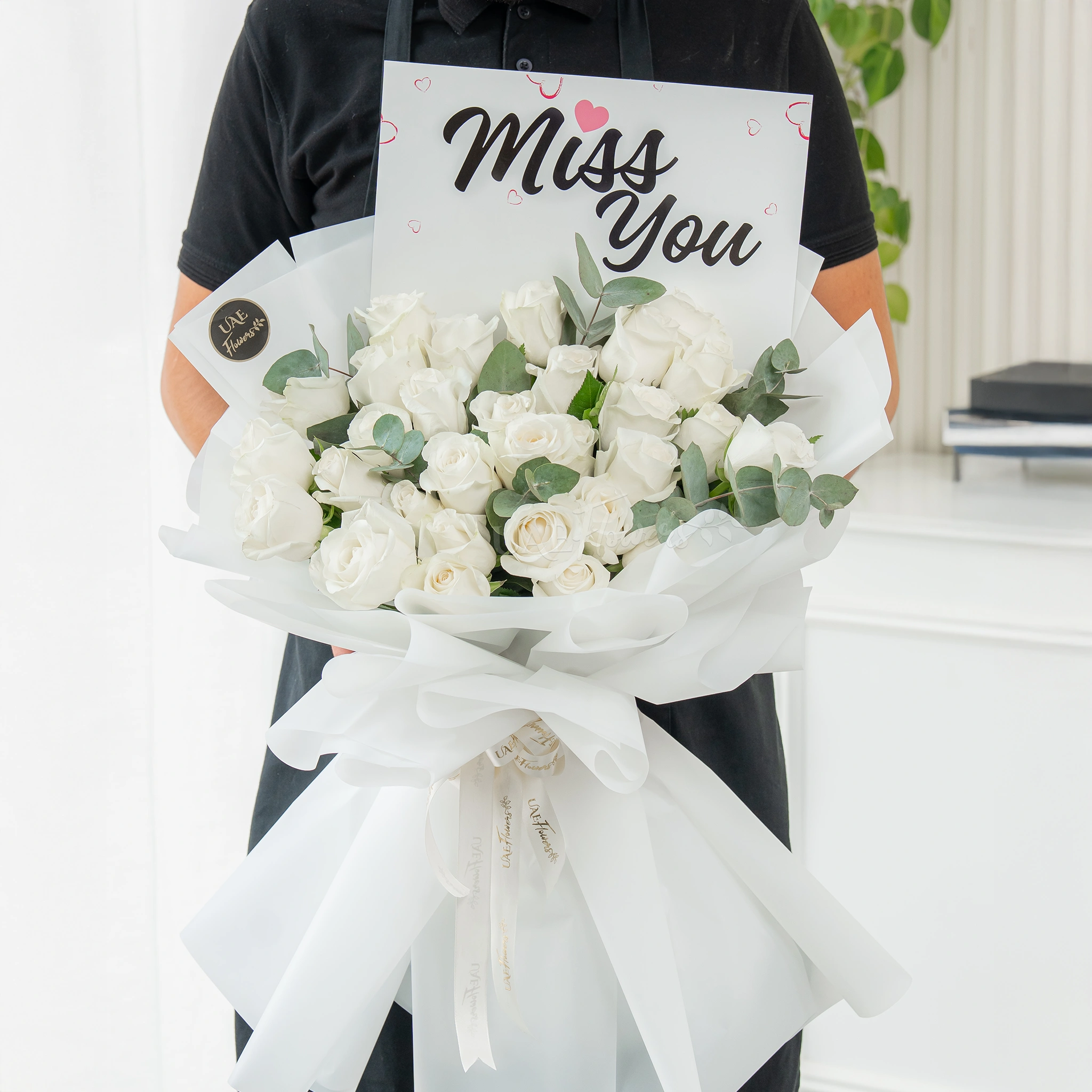 Bouquet of 25 white roses with greens in nice wrapping