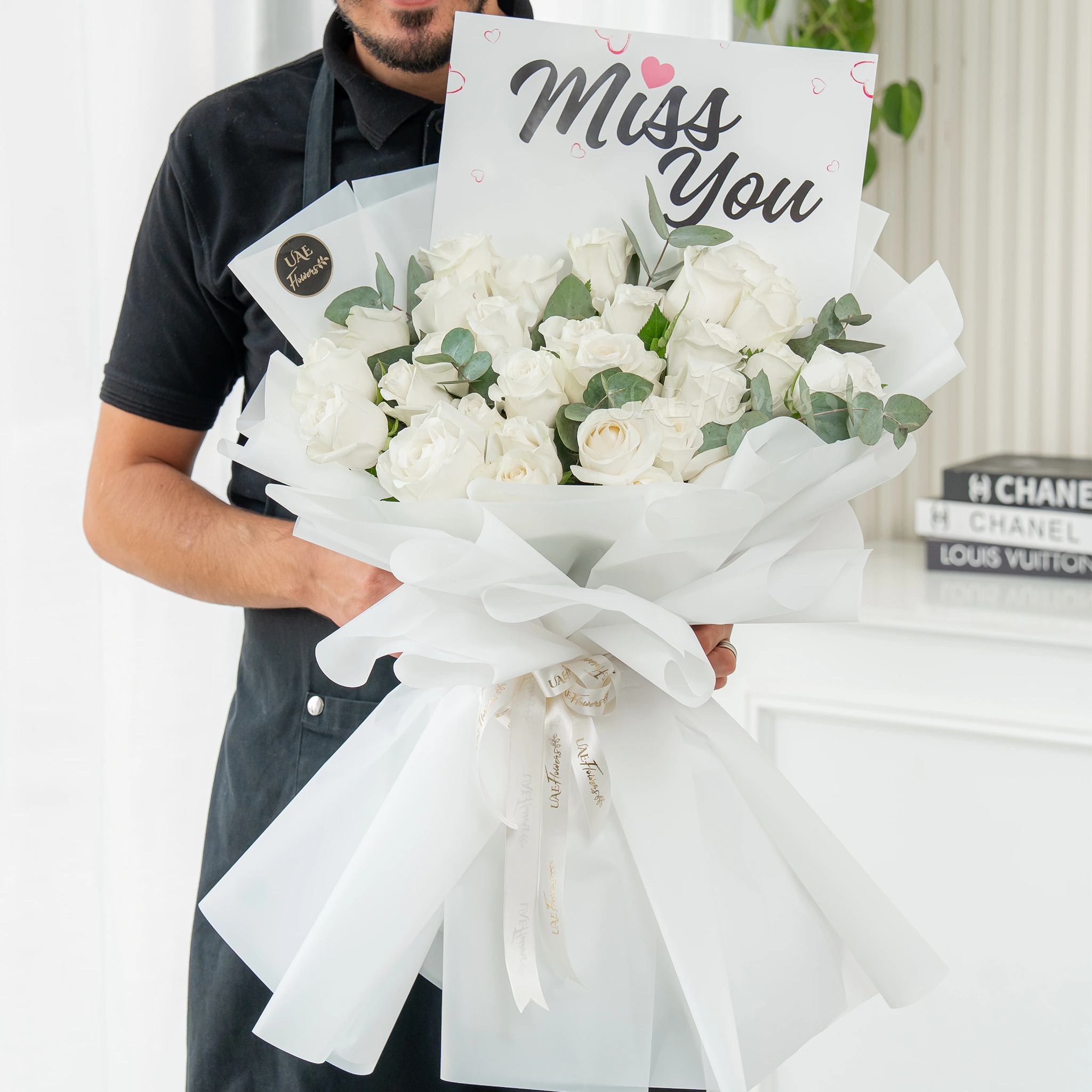 Bouquet of 25 white roses with greens in nice wrapping