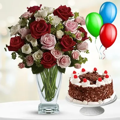 10 red, 10 pink & 10 white roses with fillers in a glass vase, 1 kg black forest cake, and 3 latex balloon