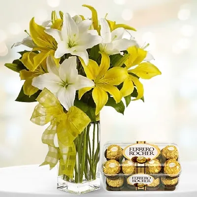 10 yellow and white lilies in a glass vase & a 16 pieces of ferrero rocher chocolate box