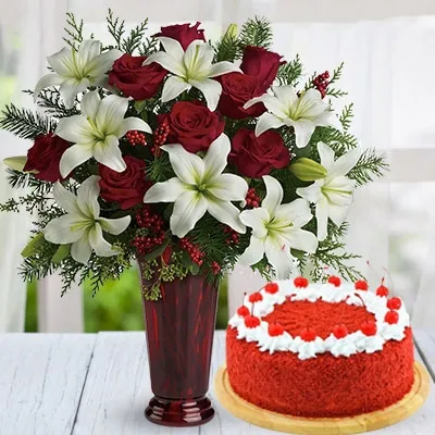 3 white oriental lilies, 10 red roses, & green fillers in a ruby red roman column glass vase & 1 kg red velvet cake