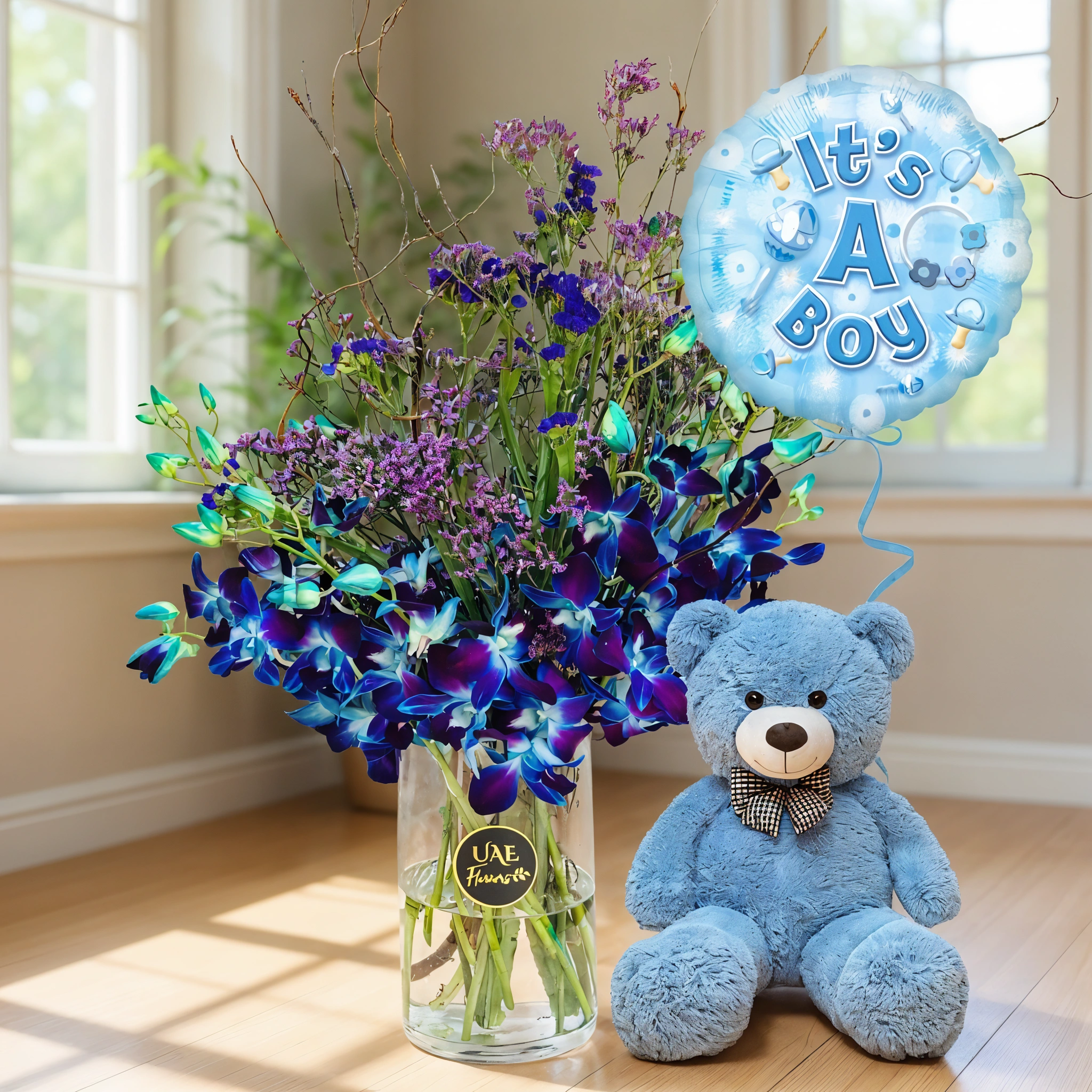 10 blue orchids in a vase, its a boy balloon, and 12 inch blue teddy bear