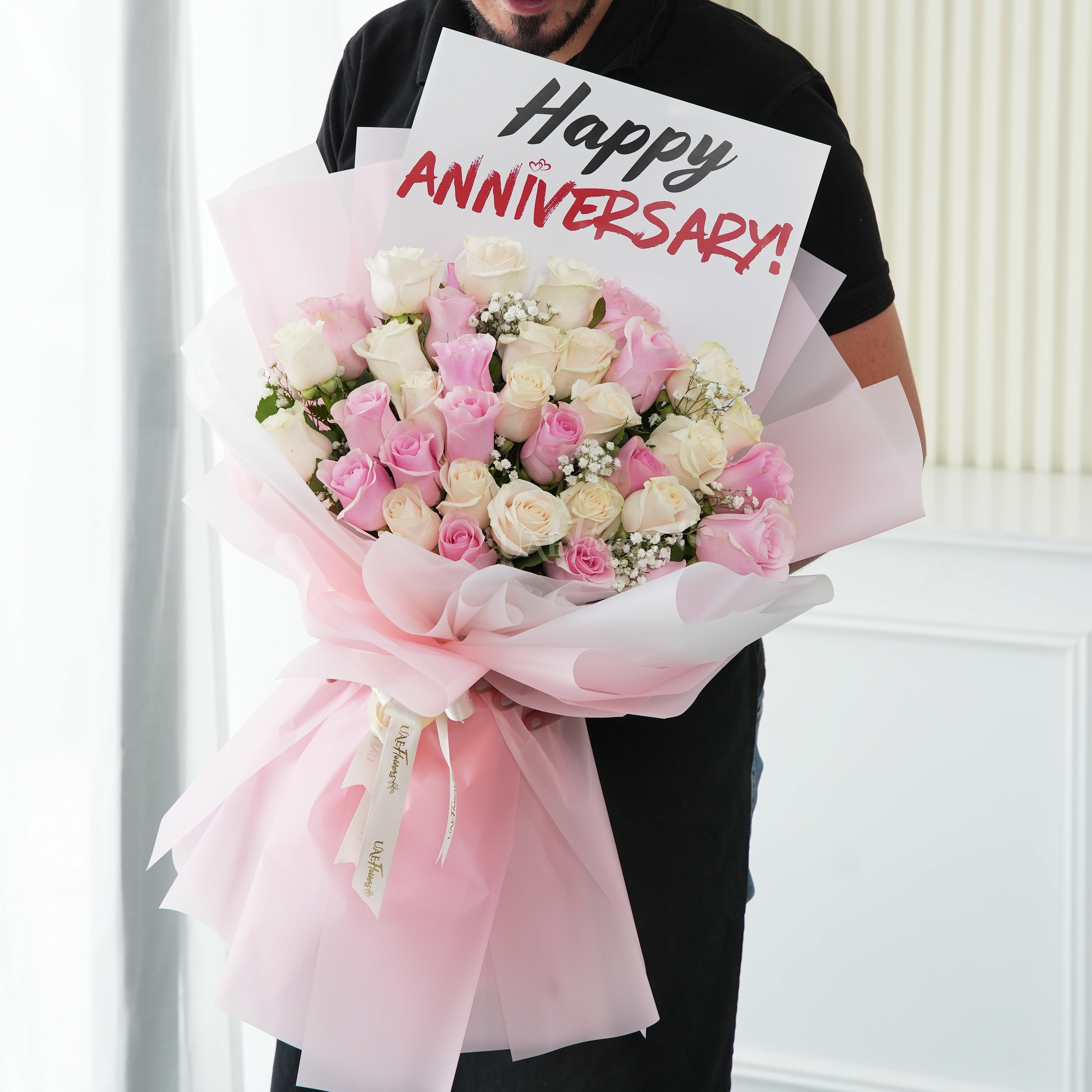 Bouquet of 15 pink roses and 20 white roses with green fillers in nice wrapping.