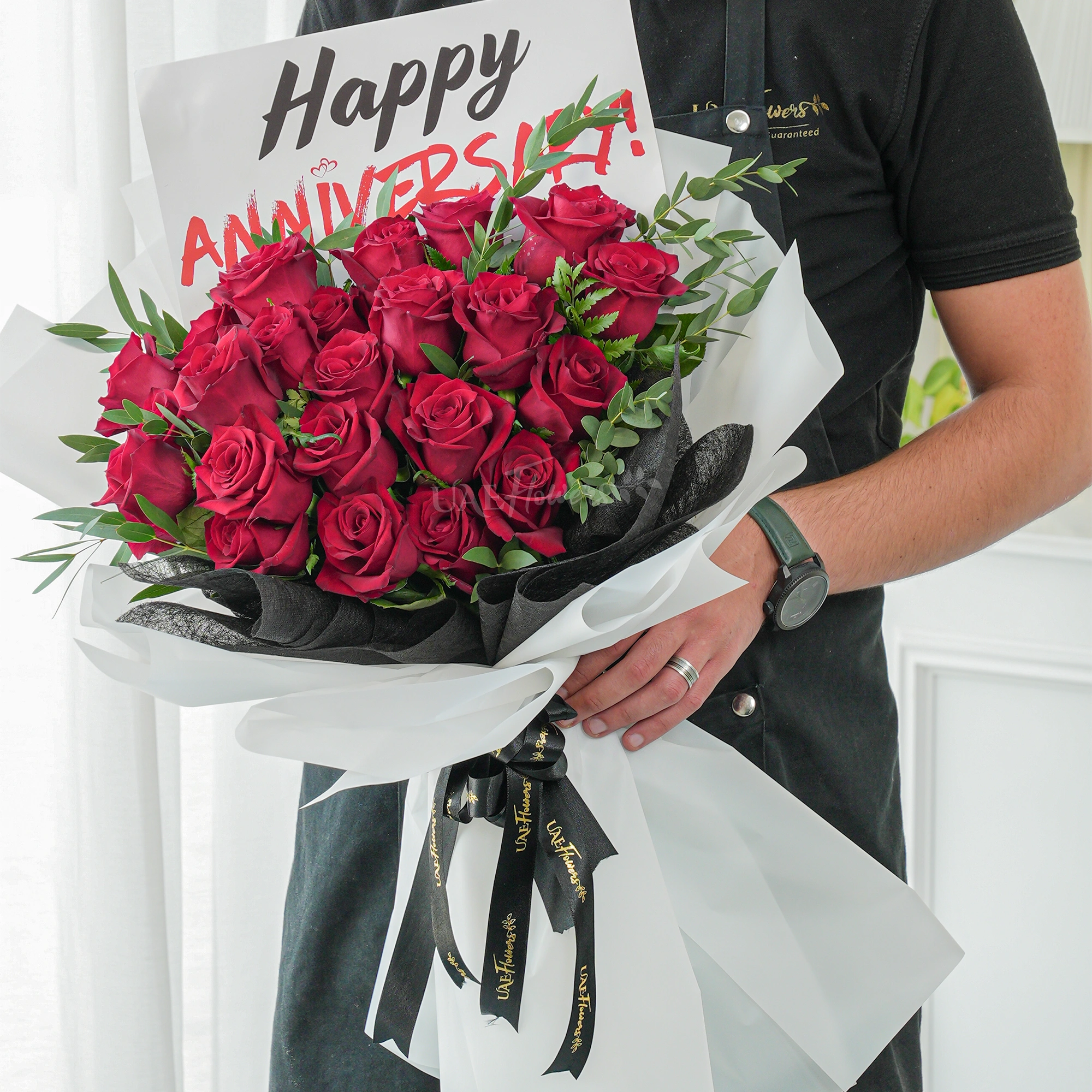 Bouquet of 20 red roses with green fillers in paper packing